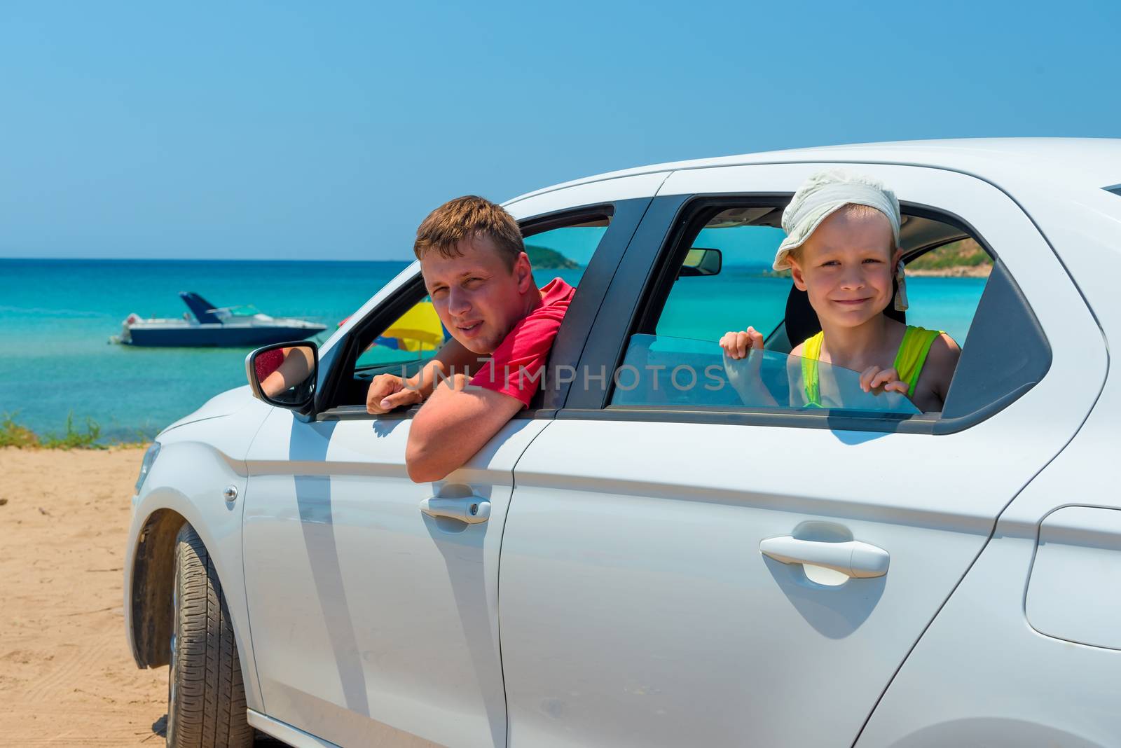 father and son went to the sea in a white car