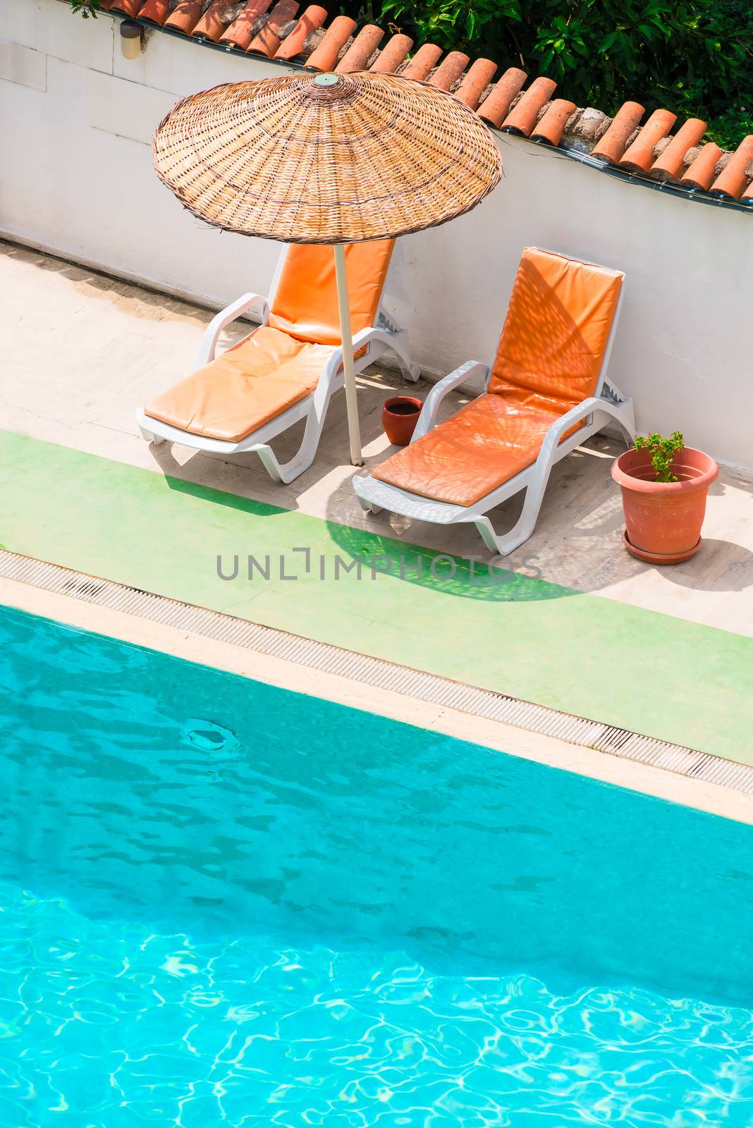 Sun loungers and parasols near the pool