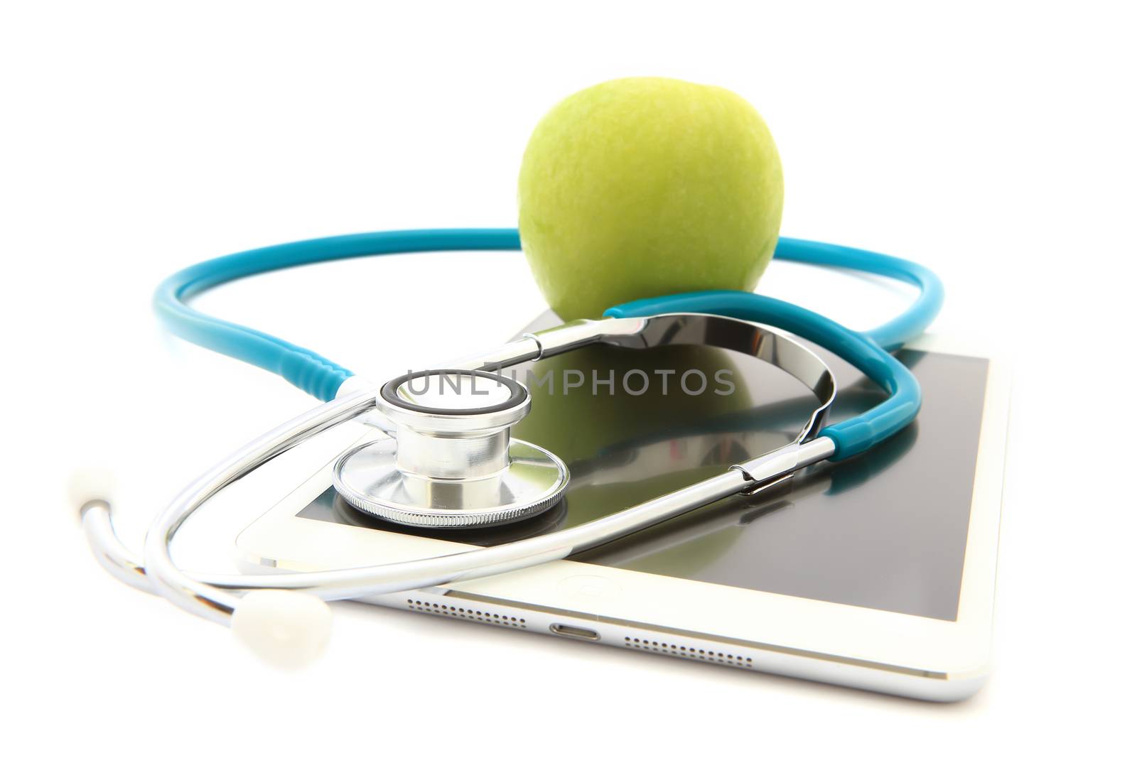 Stethoscope and green apple isolated on Tablet by rufous