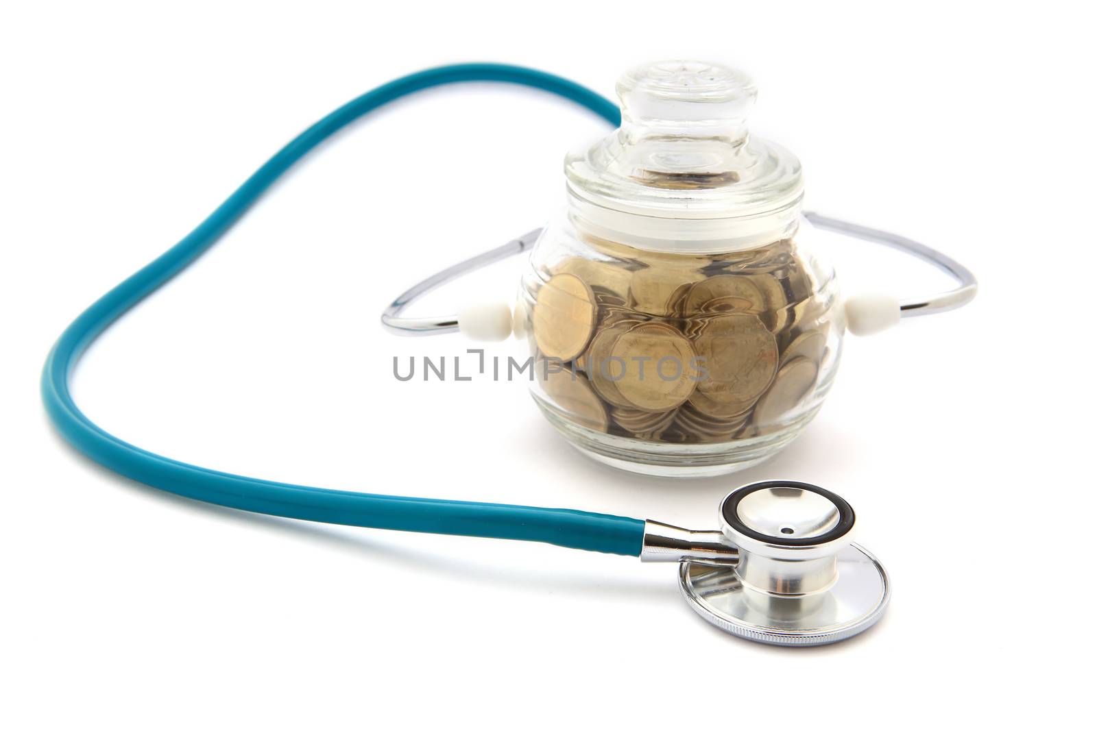 stethoscope with coins in the savings, financial concept