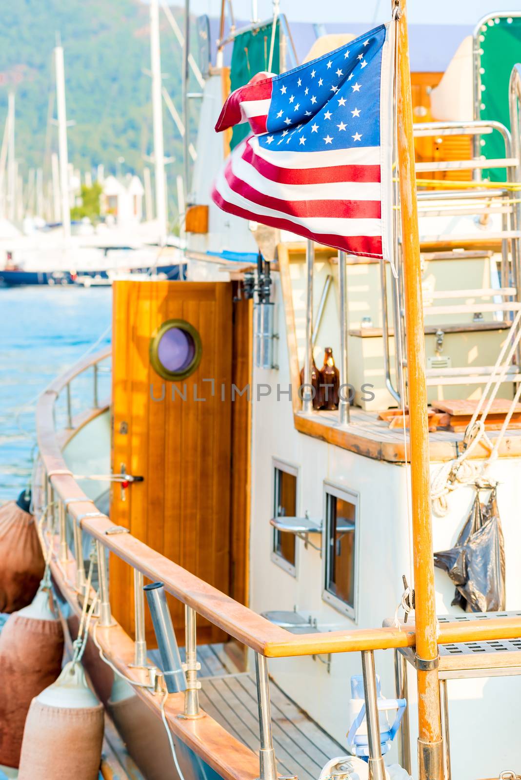 wind waving flag of America on board the yacht