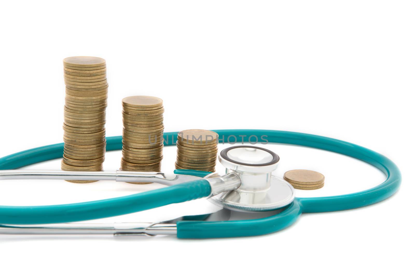 Stethoscope over coins. Concept of saving bad economy