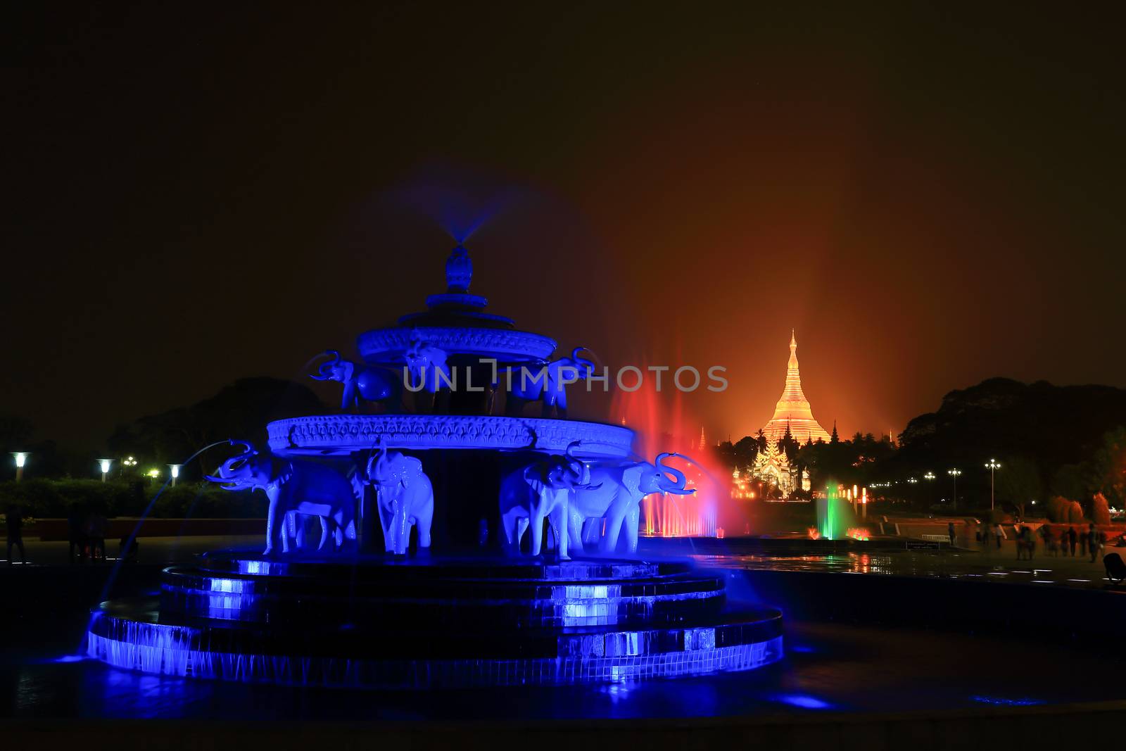 fountain with colorful illuminations at night near the Shwedagon by rufous