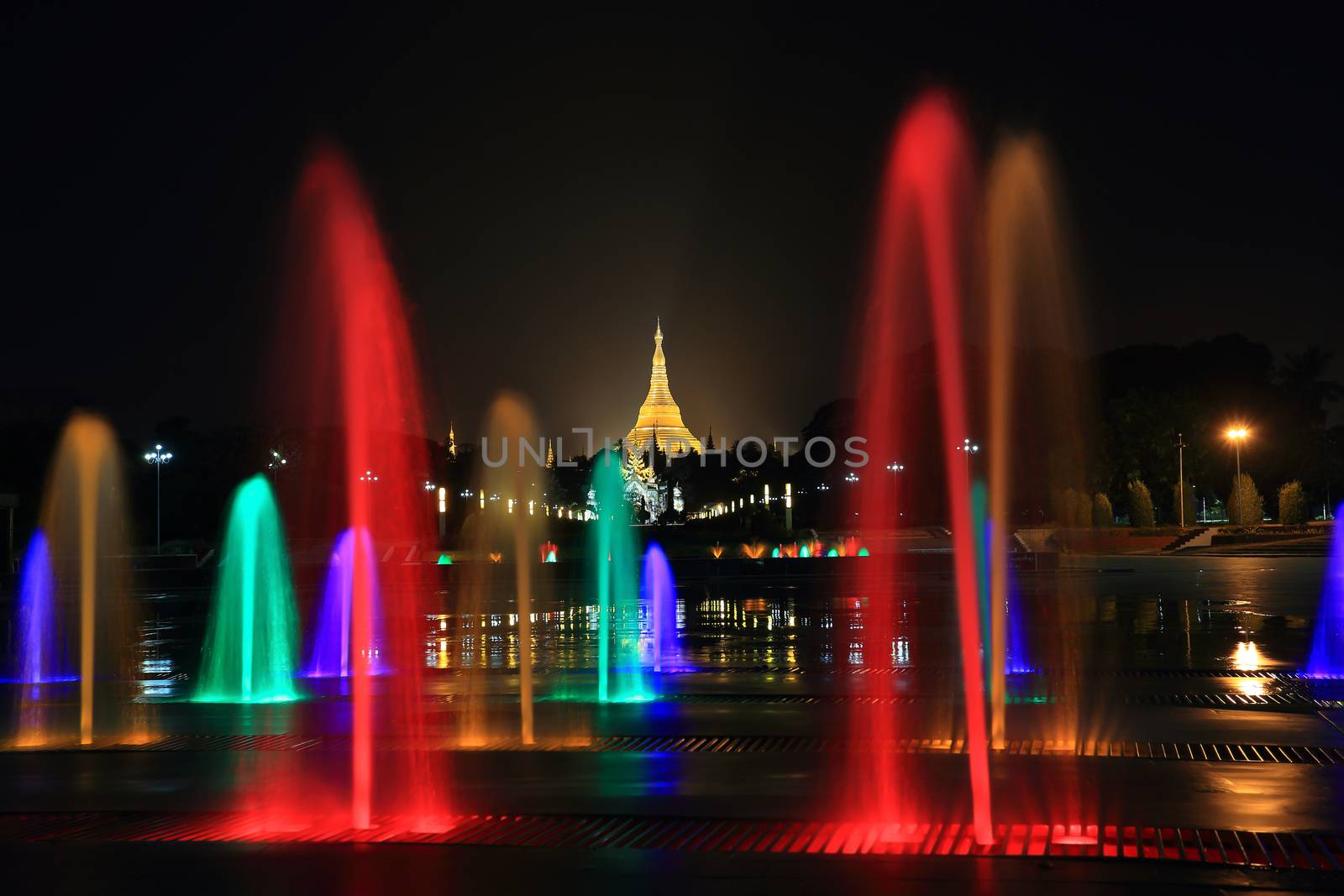 fountain with colorful illuminations at night near the Shwedagon by rufous