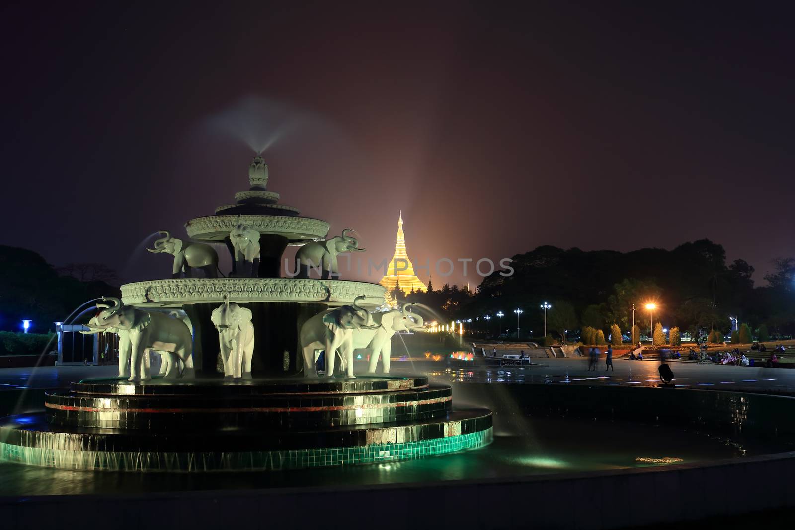 fountain with colorful illuminations at night near the Shwedagon Pagoda