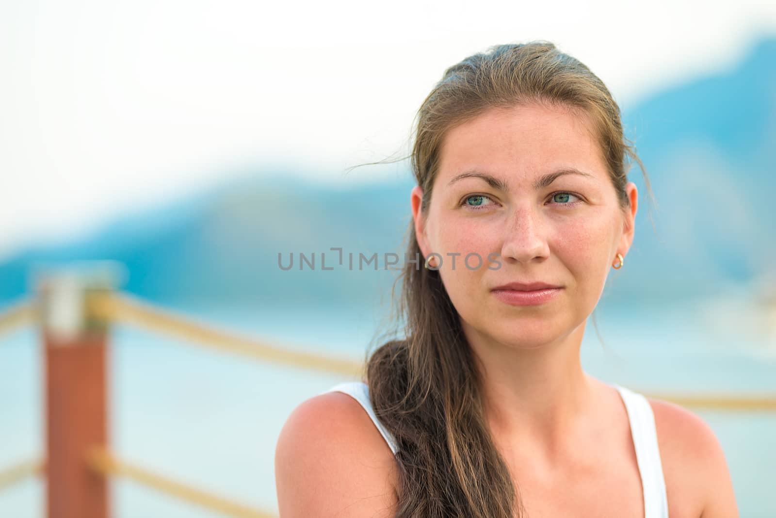 portrait of a beautiful young brunette on the pier