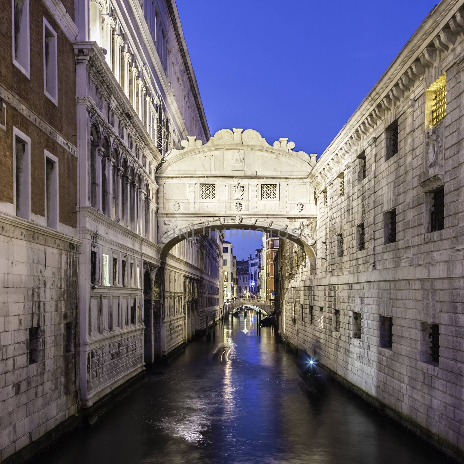Gondolas passing under Bridge of Sighs, Ponte dei Sospiri. A legend says that lovers will be granted eternal love if they kiss on a gondola at sunset under the Bridge. Venice,Veneto, Italy, Europe. 