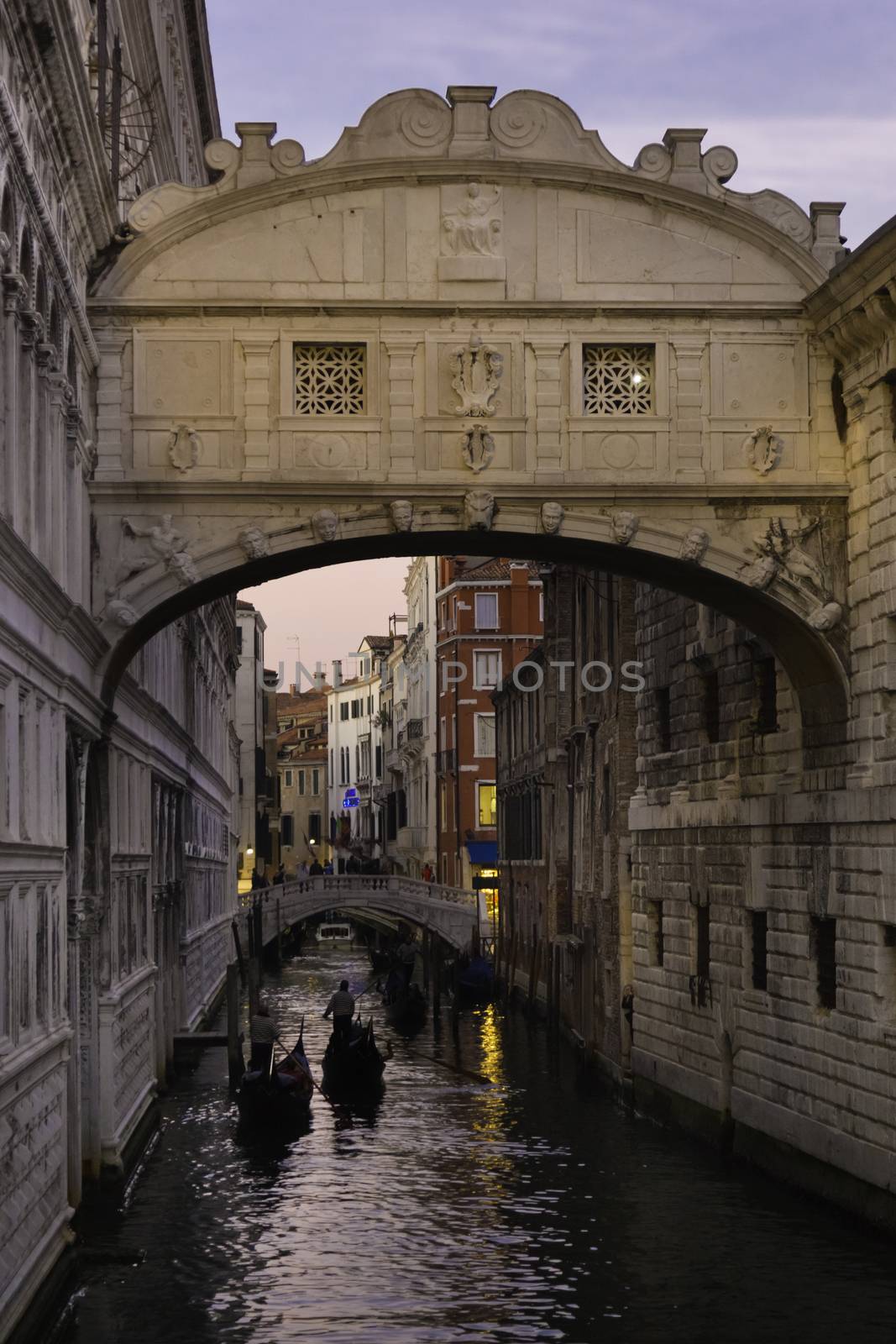 Gondolas passing under Bridge of Sighs, Ponte dei Sospiri. A legend says that lovers will be granted eternal love if they kiss on a gondola at sunset under the Bridge. Venice,Veneto, Italy, Europe. 