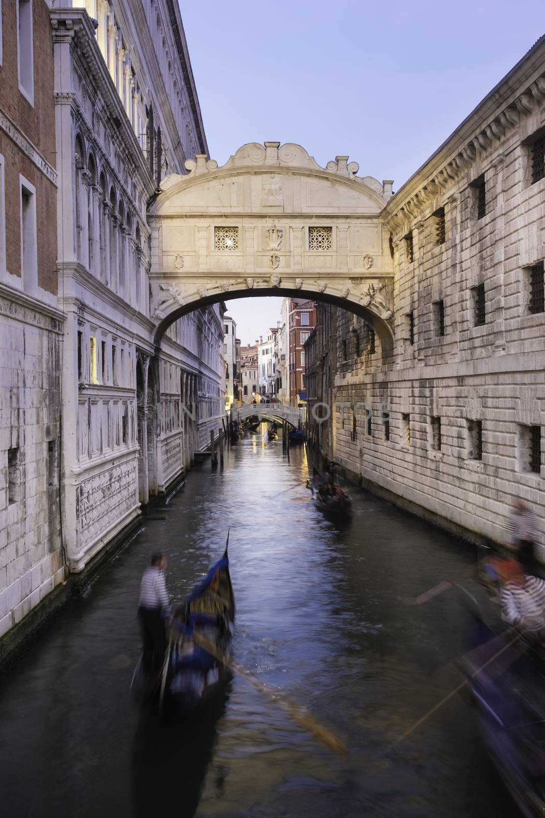 Gondolas passing under Bridge of Sighs, Ponte dei Sospiri. A legend says that lovers will be granted eternal love if they kiss on a gondola at sunset under the Bridge. Venice,Veneto, Italy, Europe. 