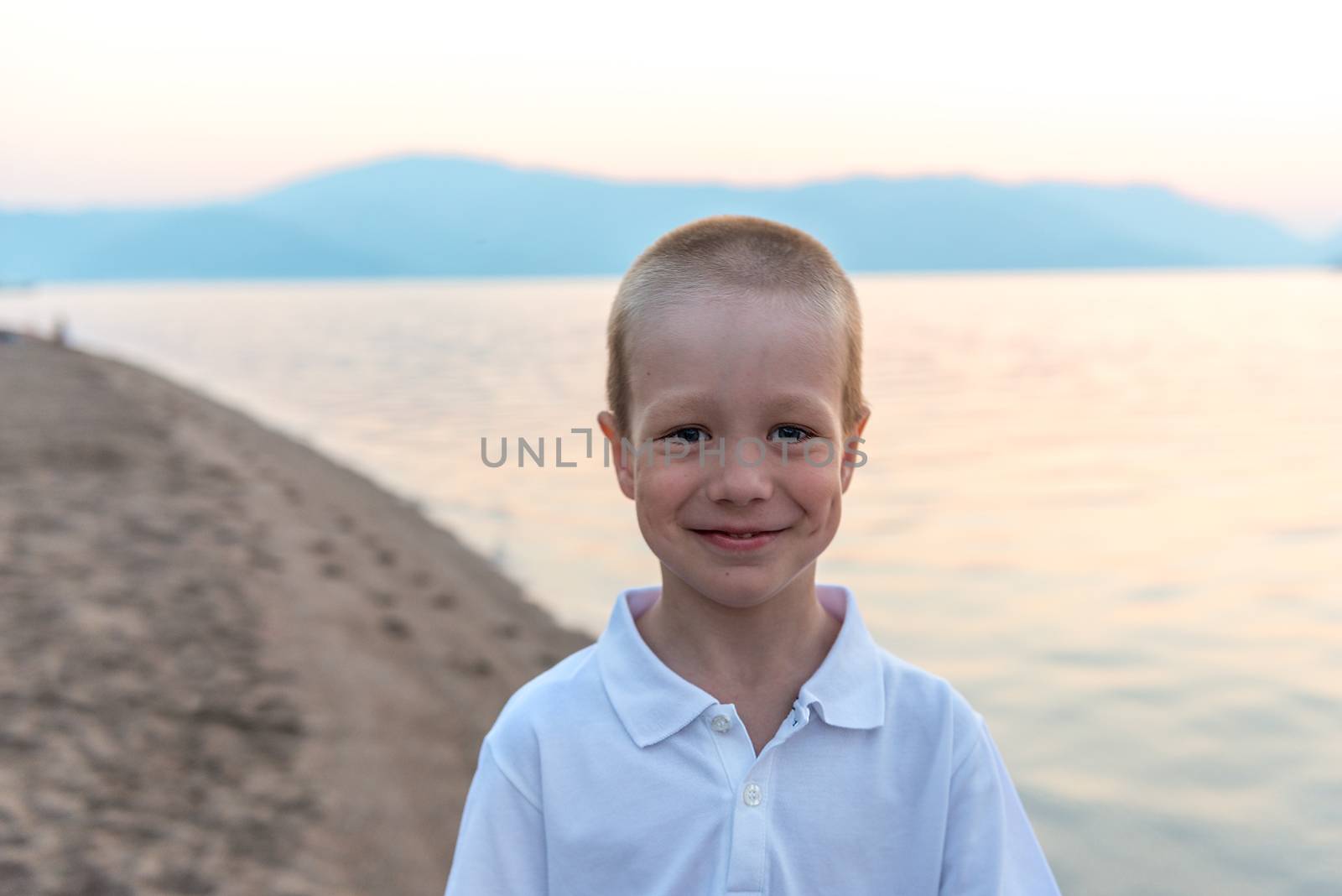 Portrait of a little boy on the beach at sunrise by kosmsos111