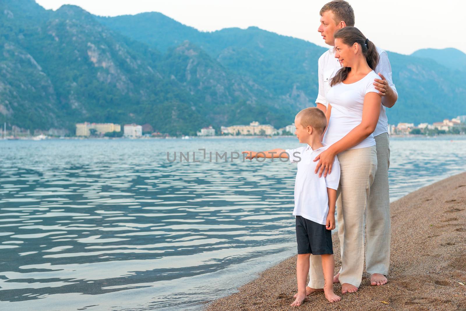 boy showing his parents at sea