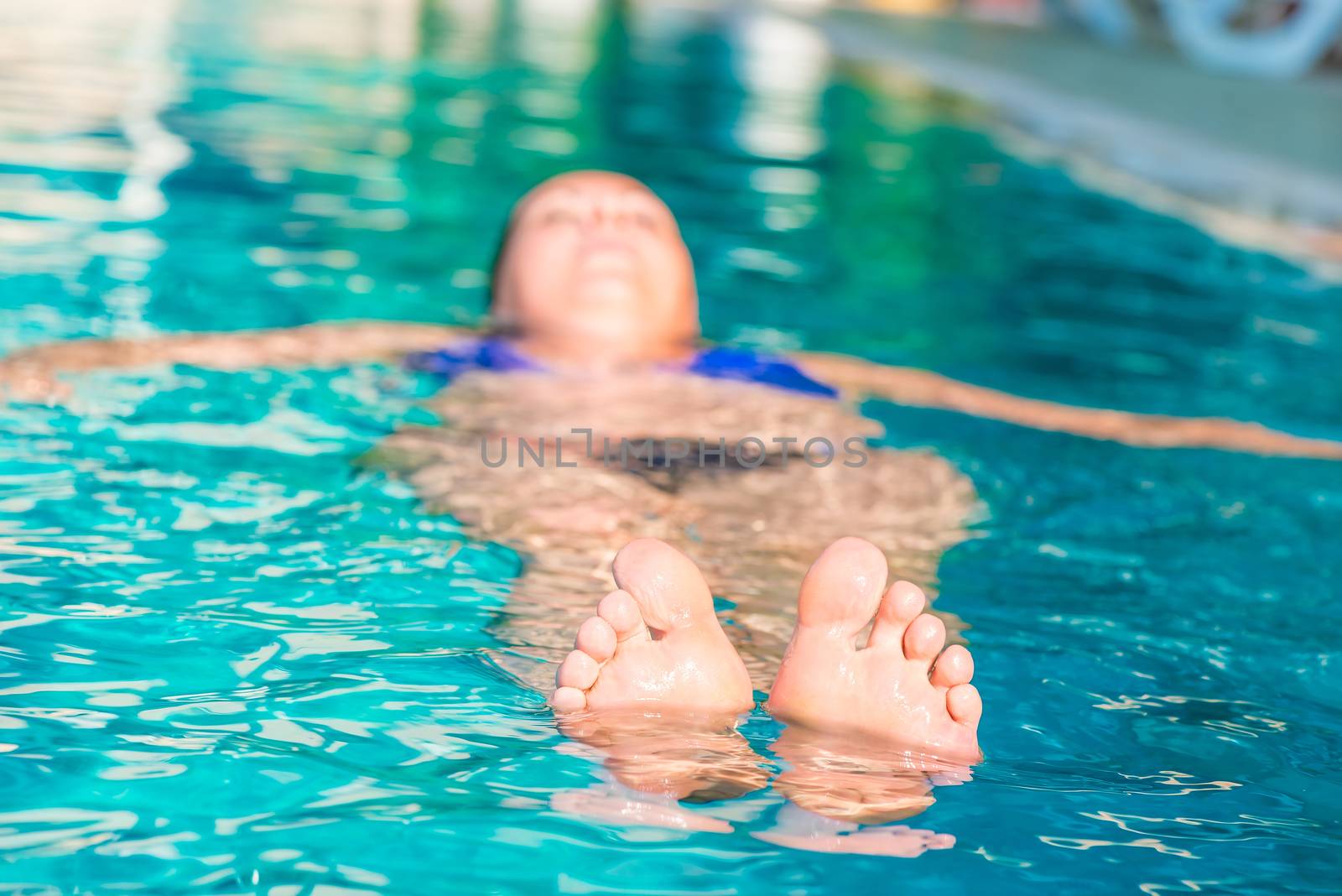 toes peeking out of the water in the pool
