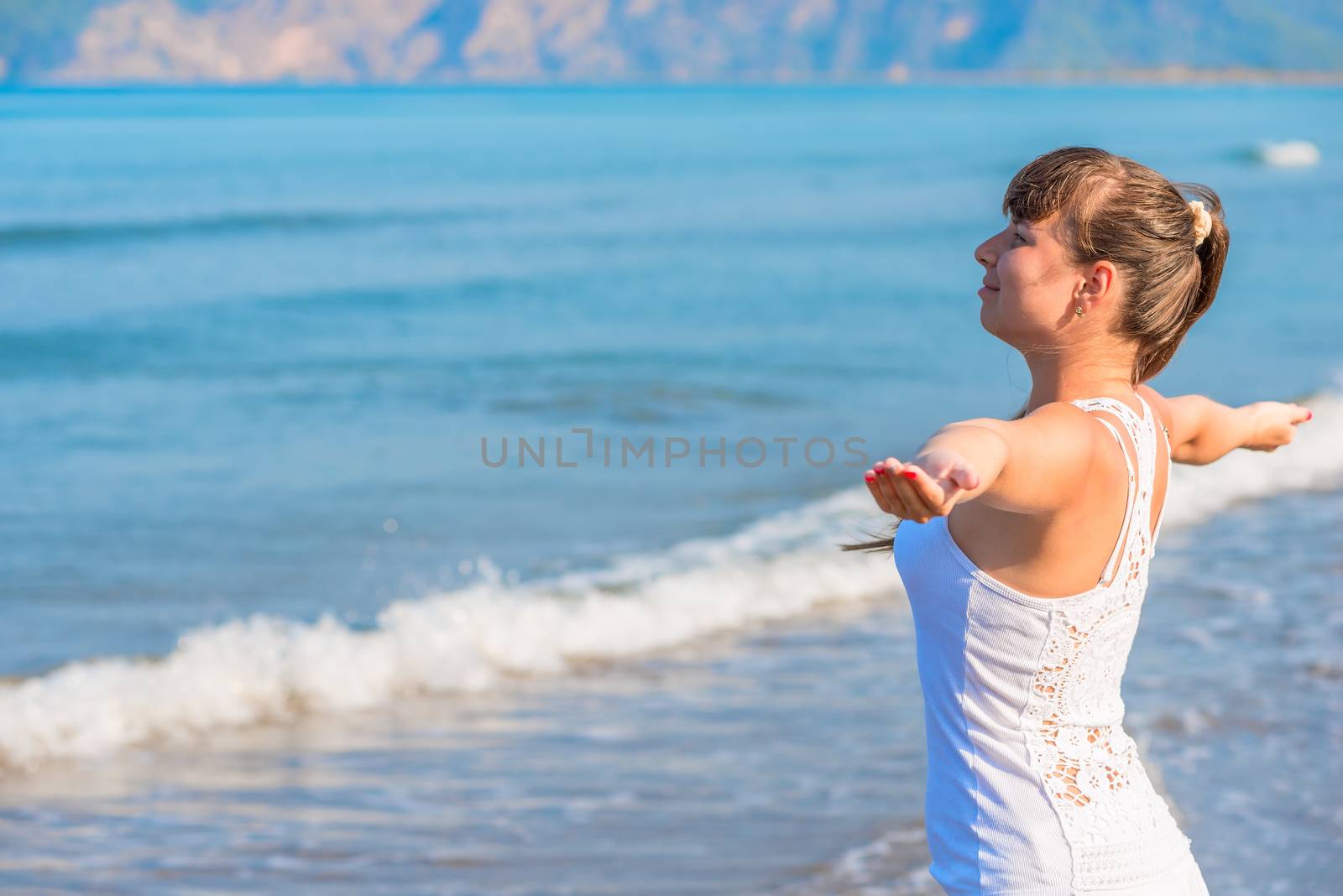 happy beautiful brunette woman looking at the sea