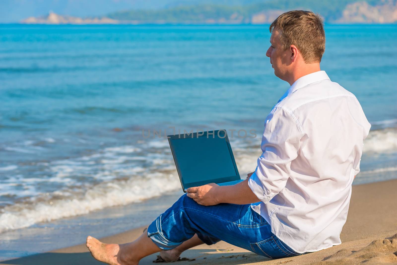 Lost businessman working on a deserted island