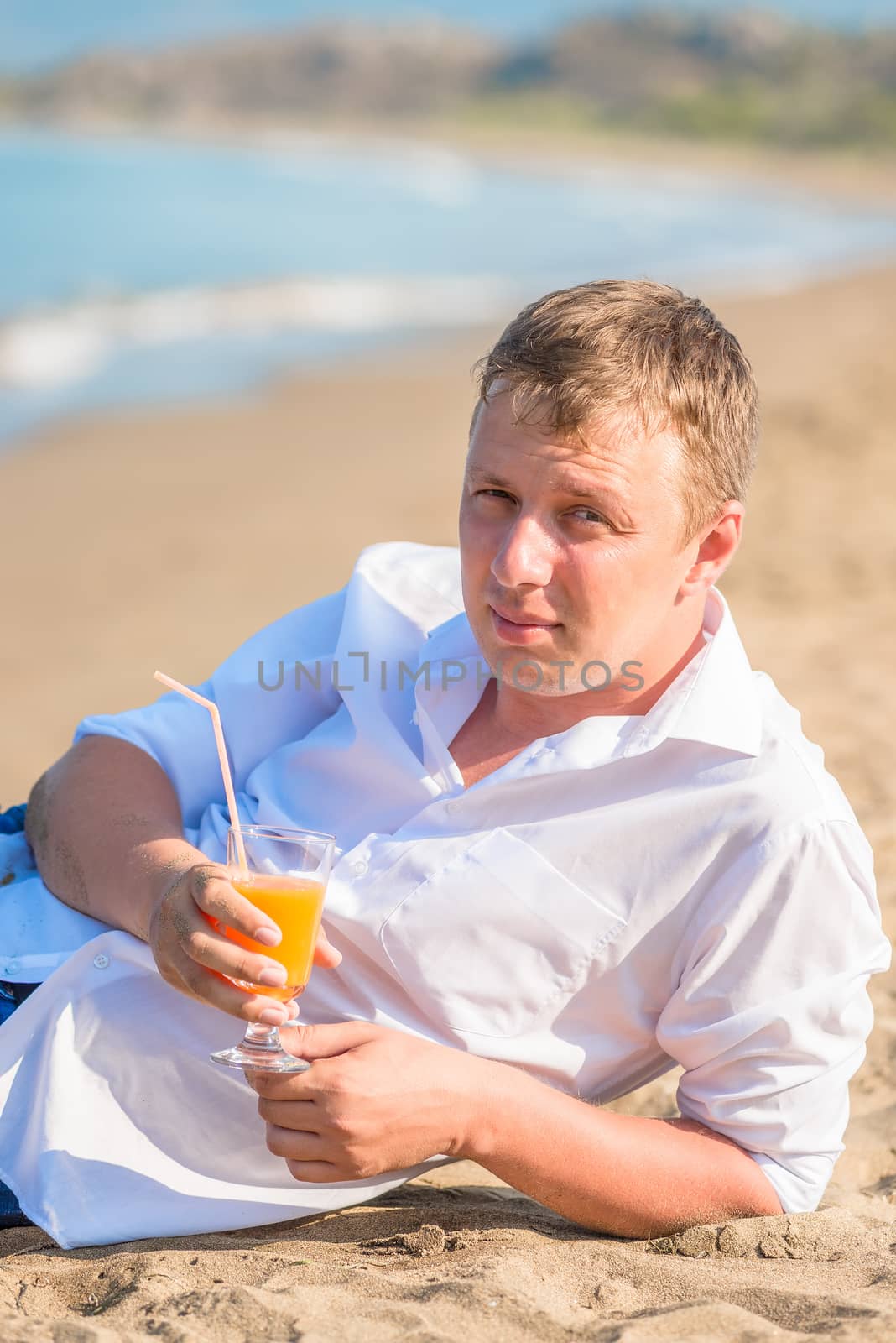 portrait of a young handsome man with glass of cocktail by kosmsos111