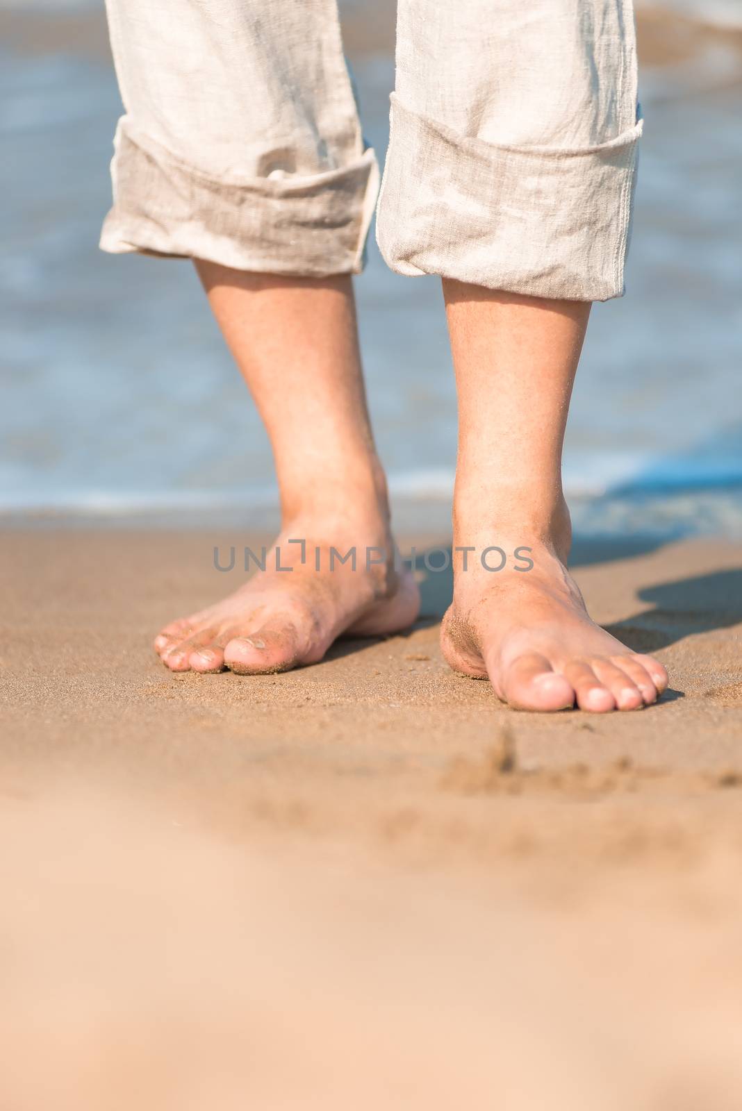 bare feet in the men's linen trousers near the sea by kosmsos111