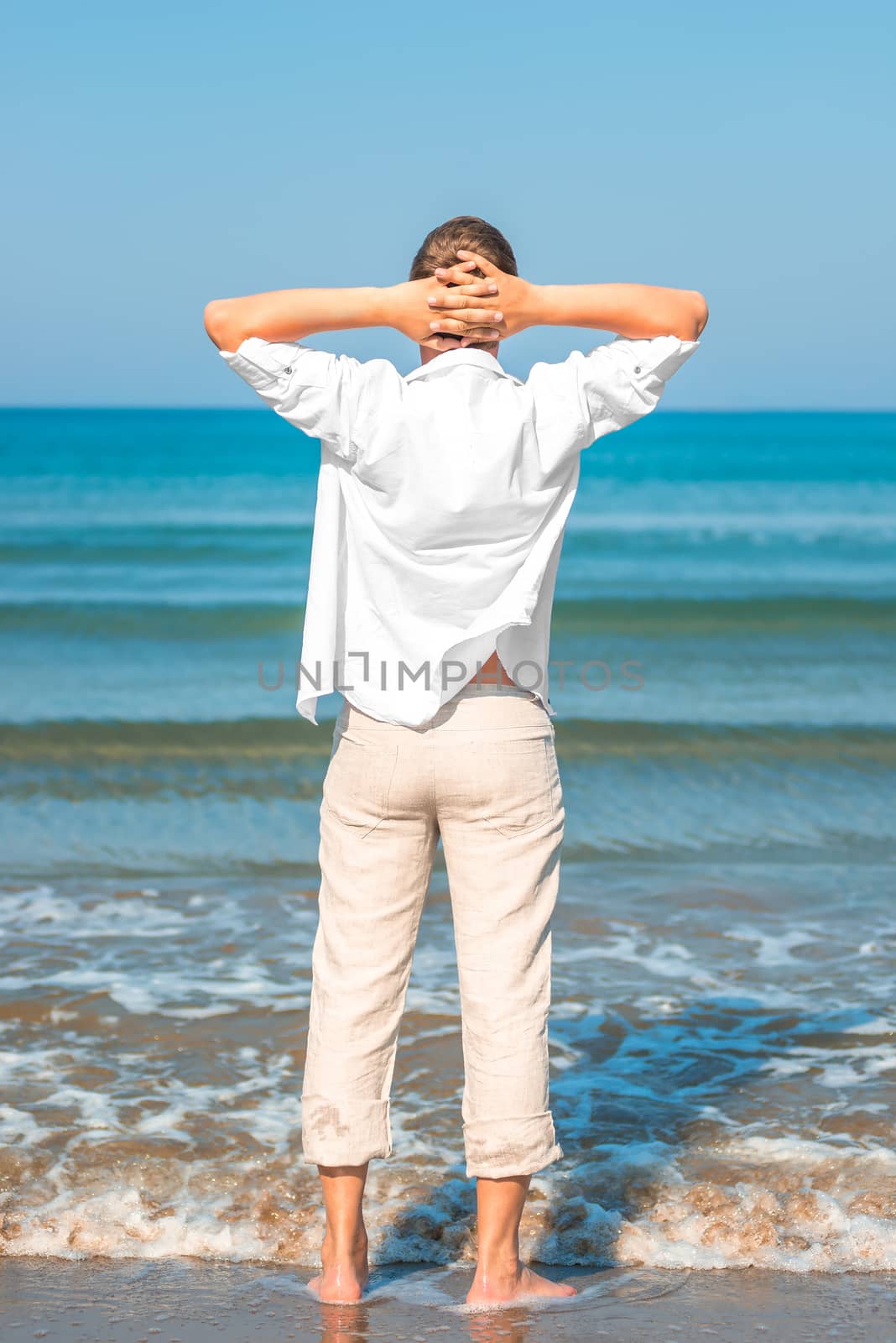 tourists on the beach in white clothing by kosmsos111