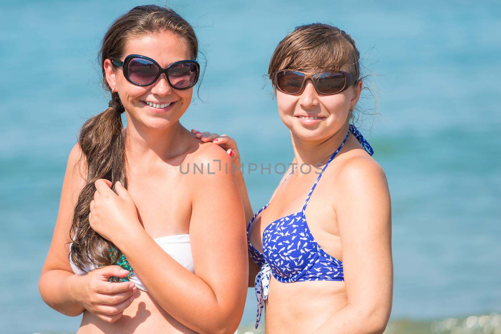 Portrait of of girlfriends with a beautiful smile on the beach by kosmsos111