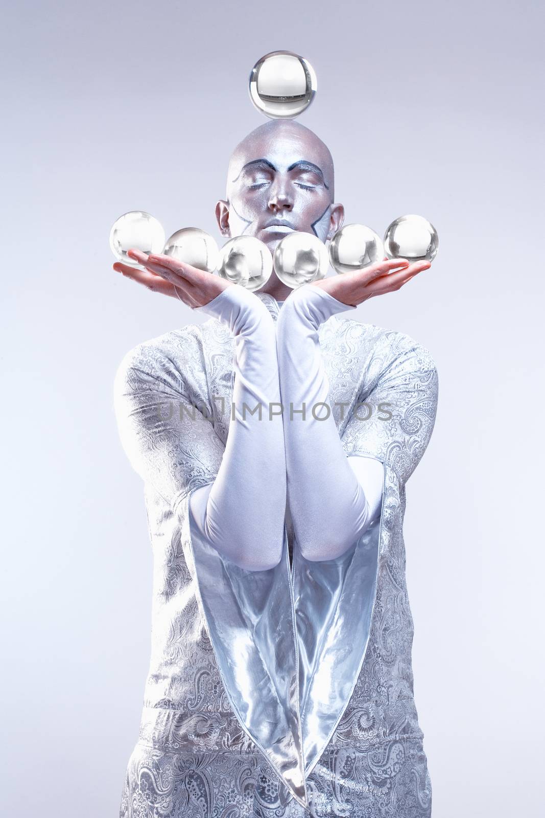 Magician with Glass Balls in Stage Makeup and Costume