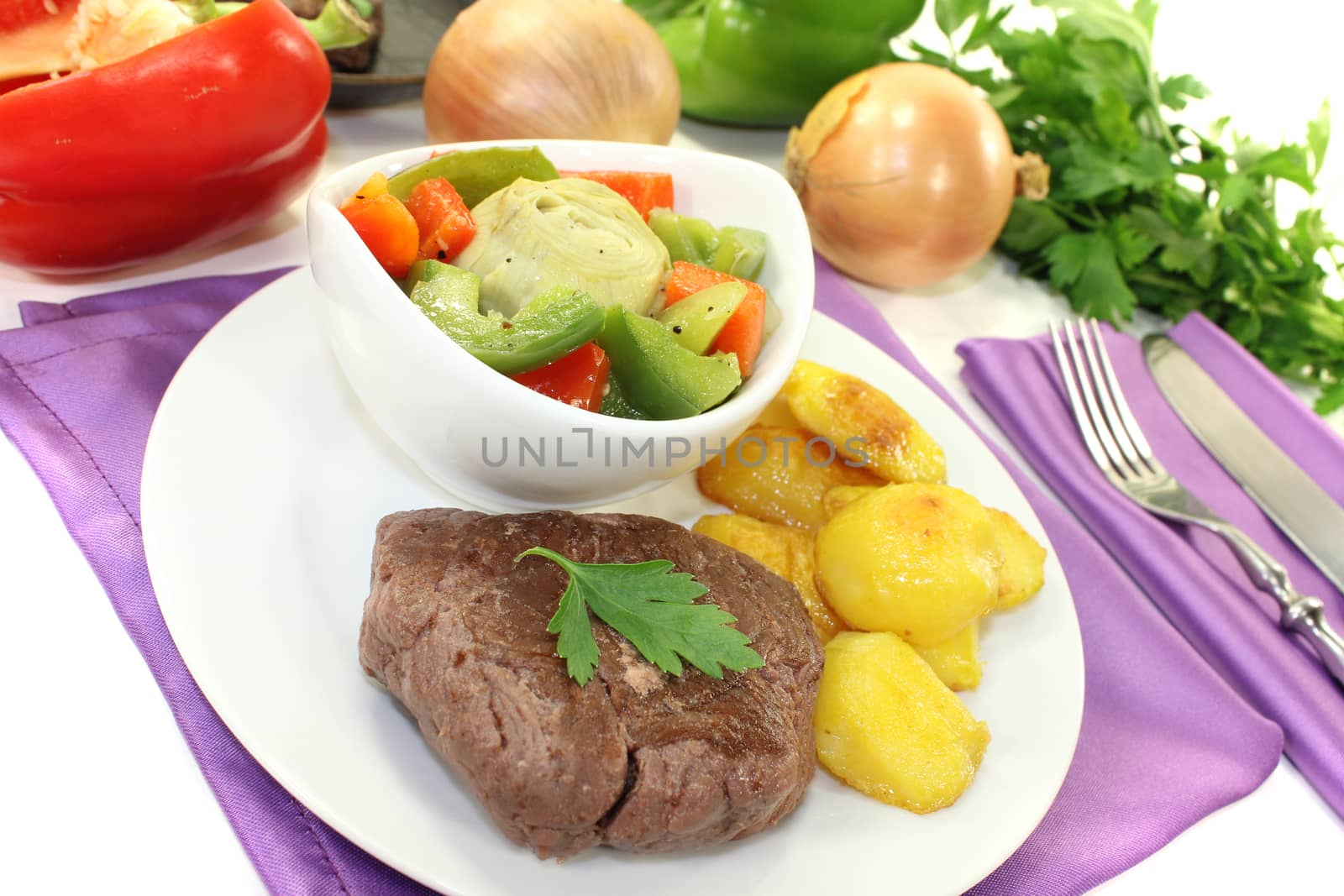 Ostrich steaks with baked potatoes on bright background