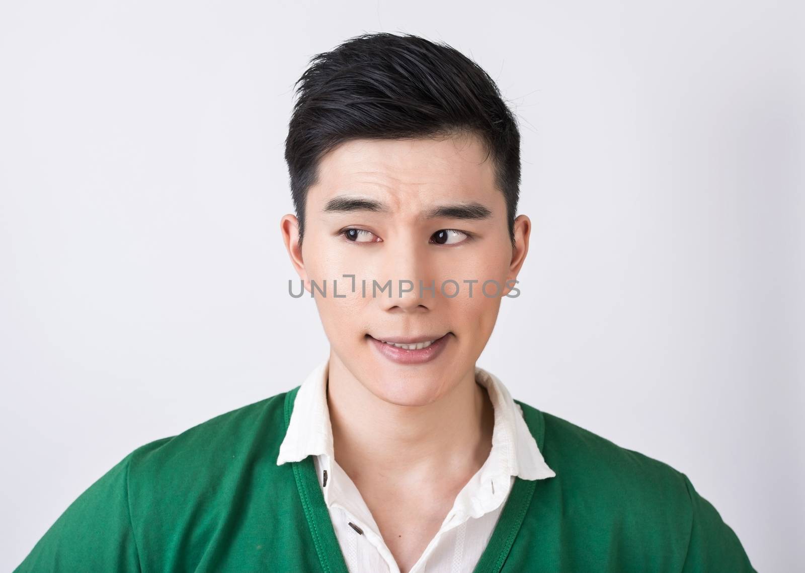 Funny facial expression, closeup Asian young man.