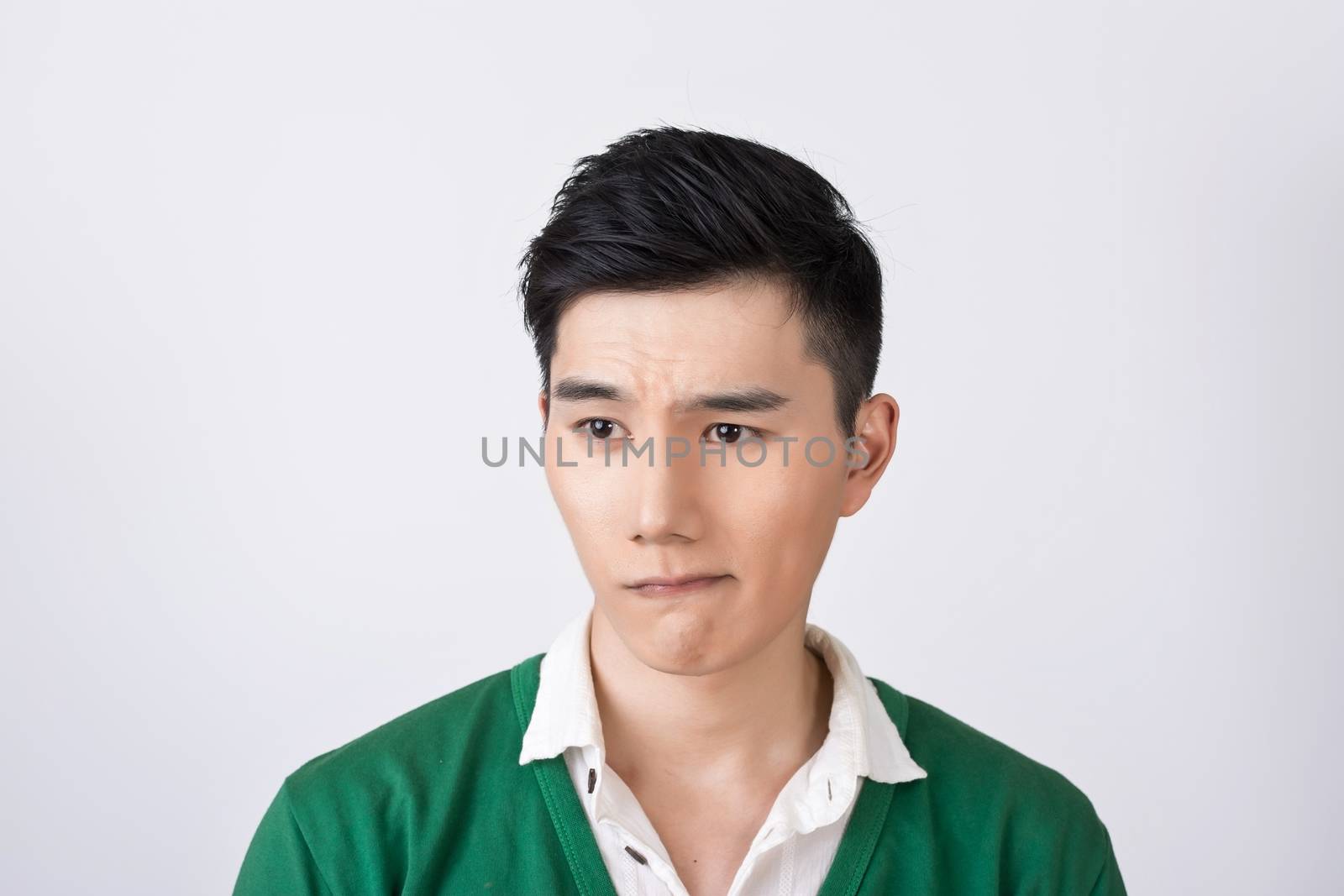 Funny facial expression, closeup Asian young man.