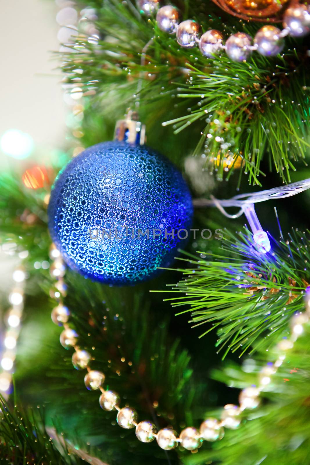 blue ball on a green New Year tree