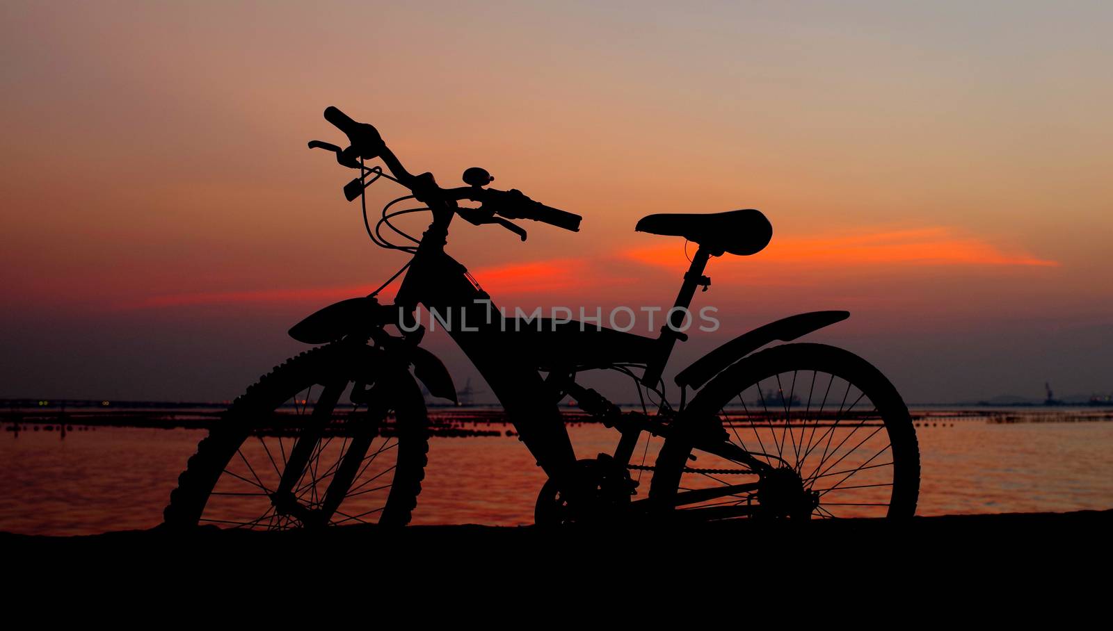 Mountain bike silhouette with sunset sky, Thailand 