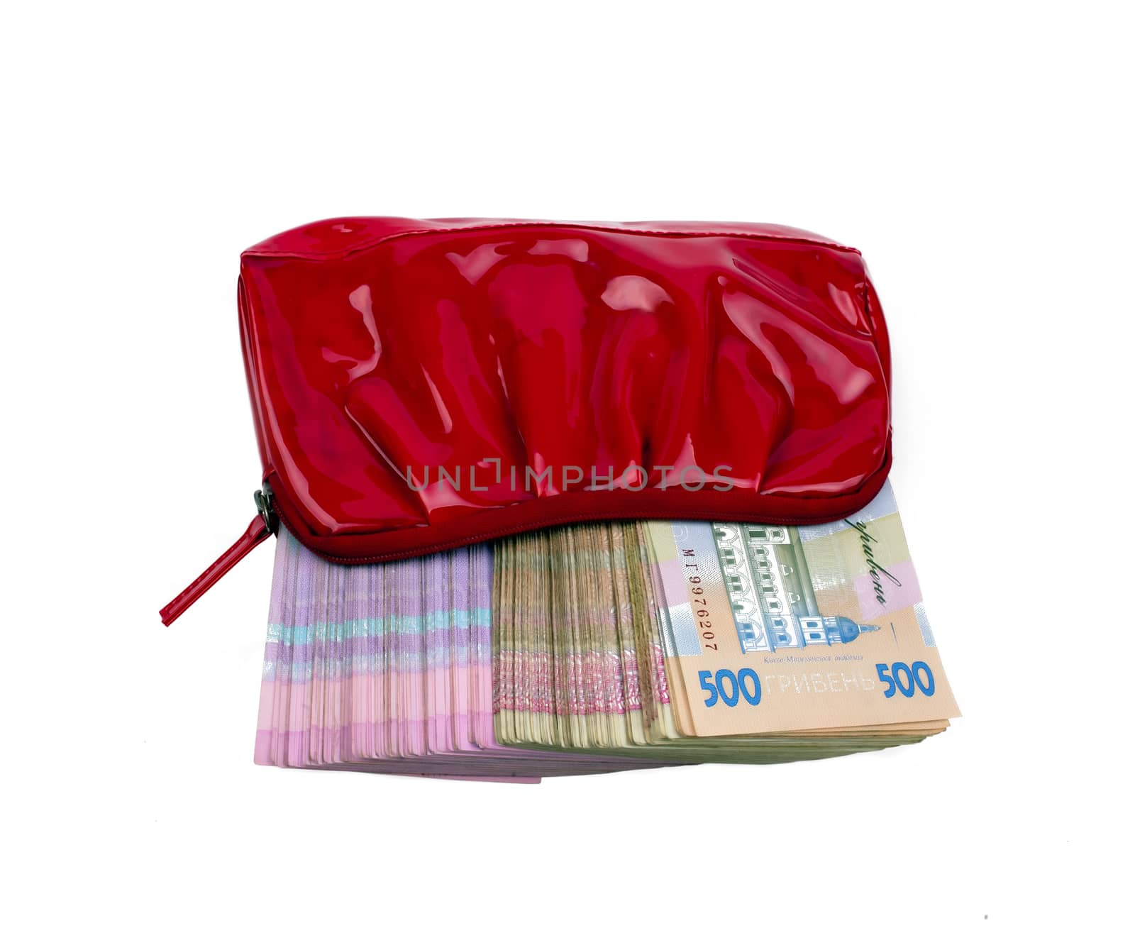 Ukrainian paper notes in red women's purse on a white background