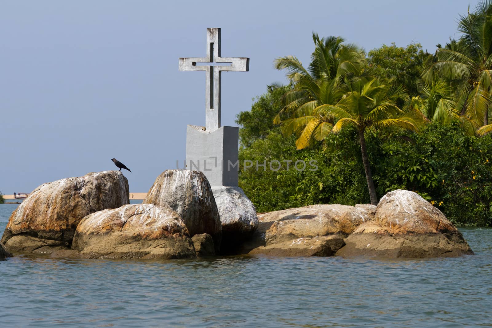 The Christian cross on a small island in backwaters by straannick