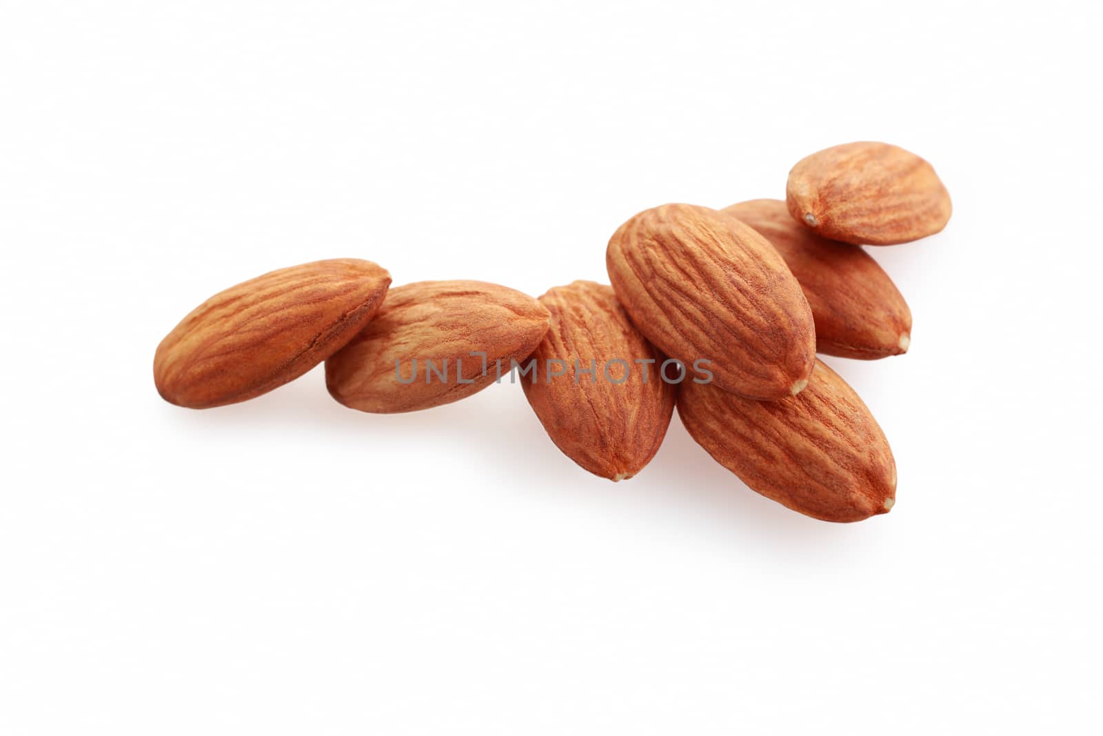 Glass bowl with almonds nuts isolated on white background.