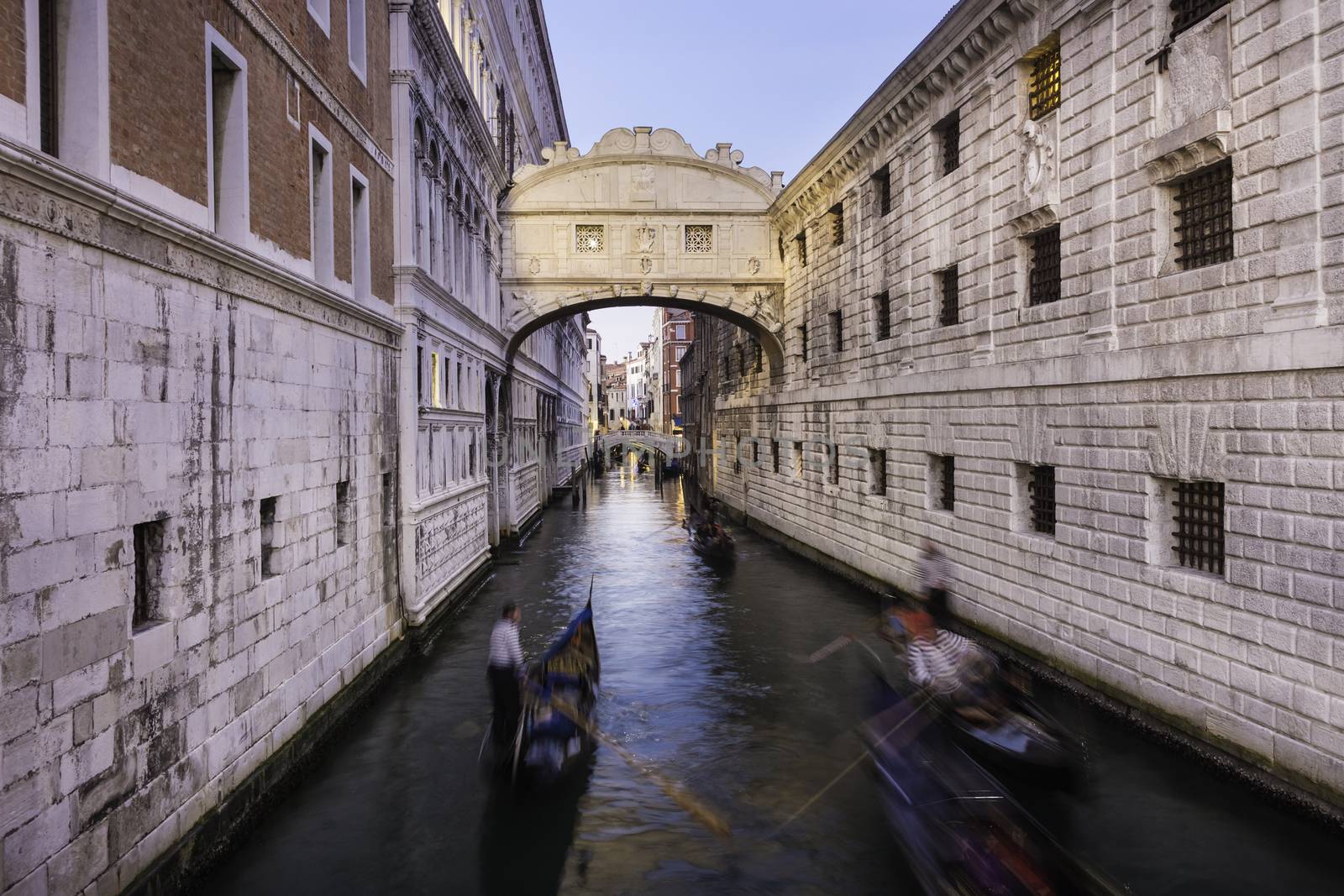 Gondolas passing under Bridge of Sighs, Ponte dei Sospiri. A legend says that lovers will be granted eternal love if they kiss on a gondola at sunset under the Bridge. Venice,Veneto, Italy, Europe. 