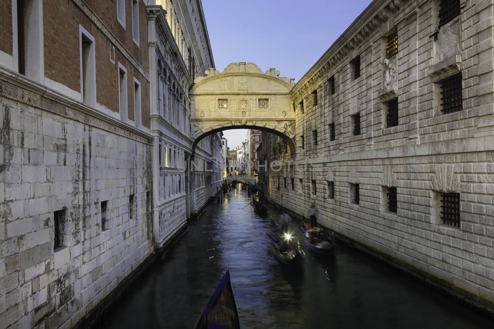 Gondolas passing under Bridge of Sighs, Ponte dei Sospiri. A legend says that lovers will be granted eternal love if they kiss on a gondola at sunset under the Bridge. Venice,Veneto, Italy, Europe. 