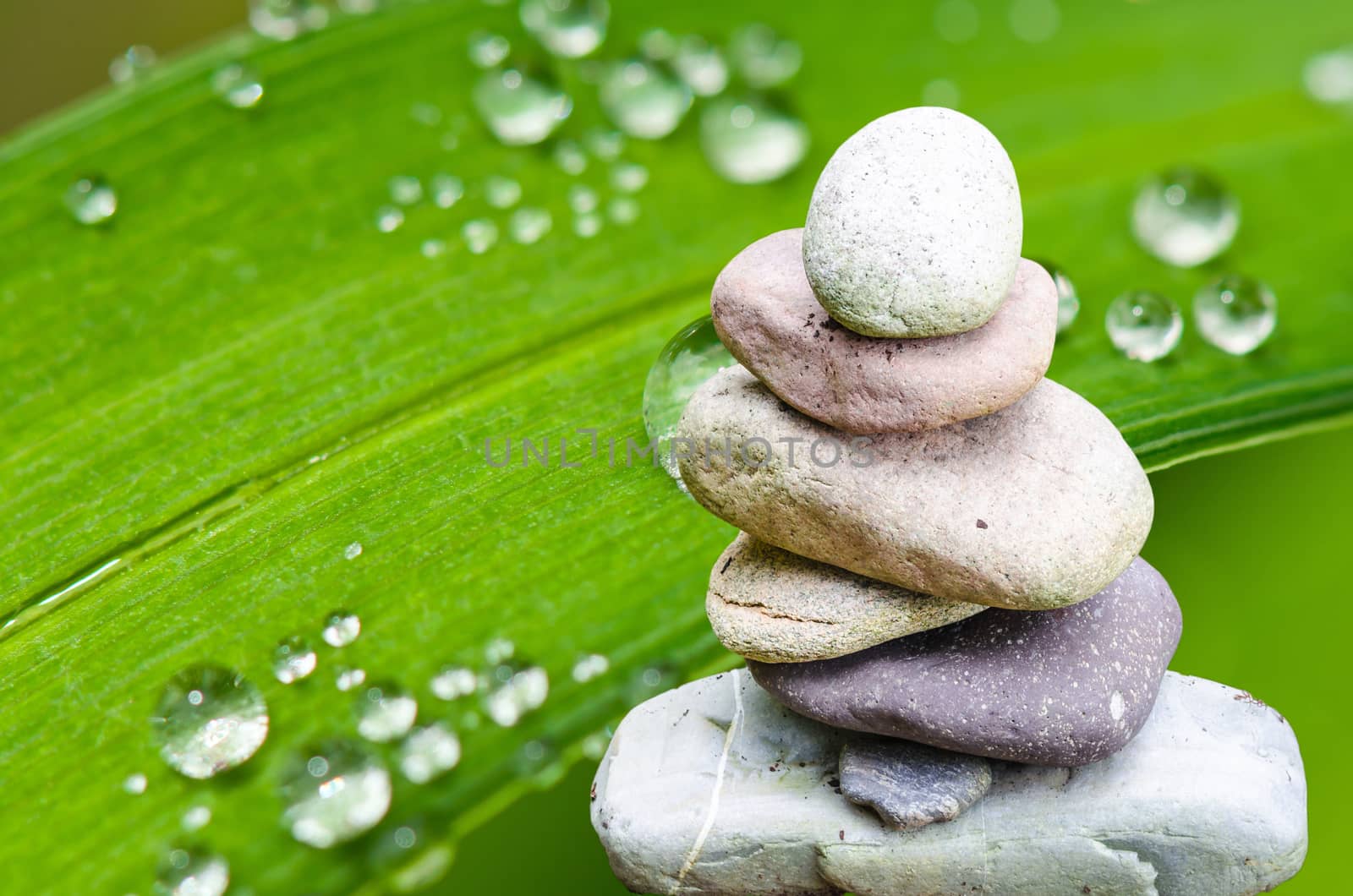 Balance, balance, serenity stone pile with bamboo leaf.