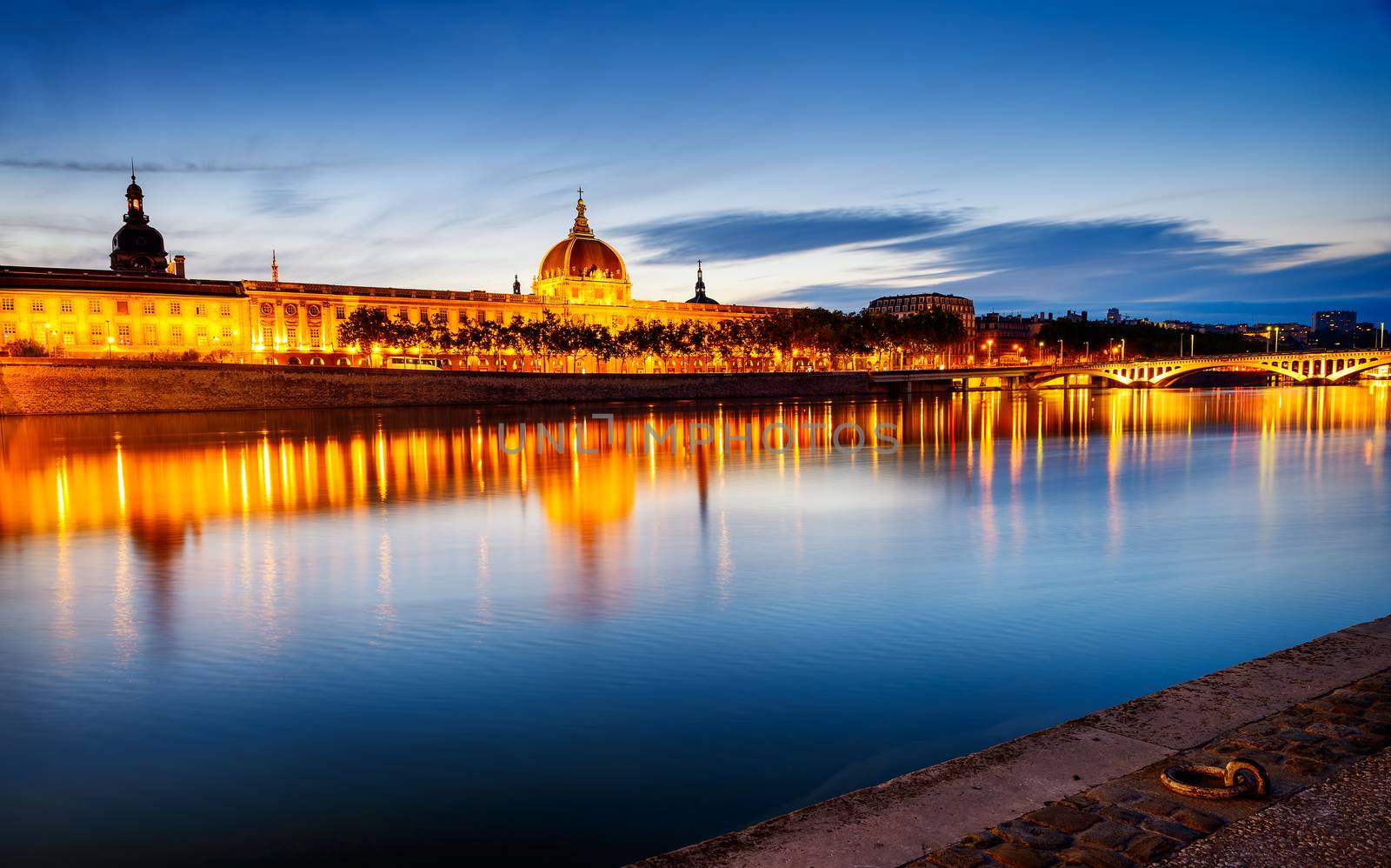 night view from Rhone river in Lyon city with Hotel Dieu and Fourviere cathedral, France