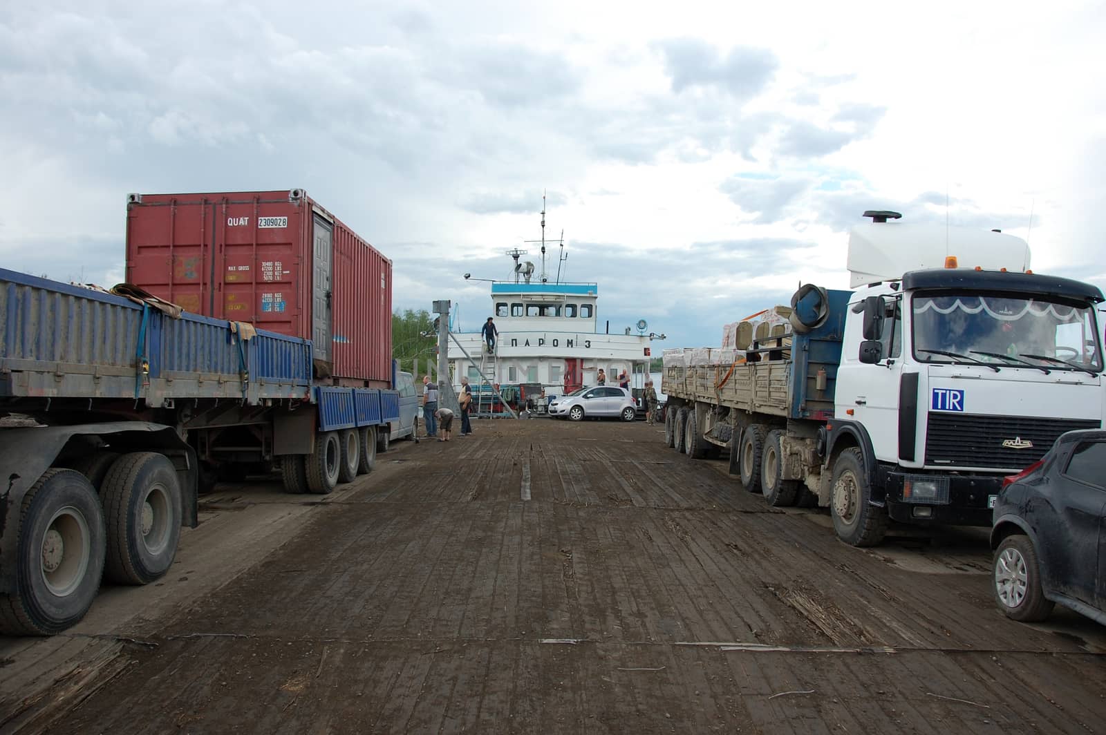 Trucks and cars at river ferry by danemo