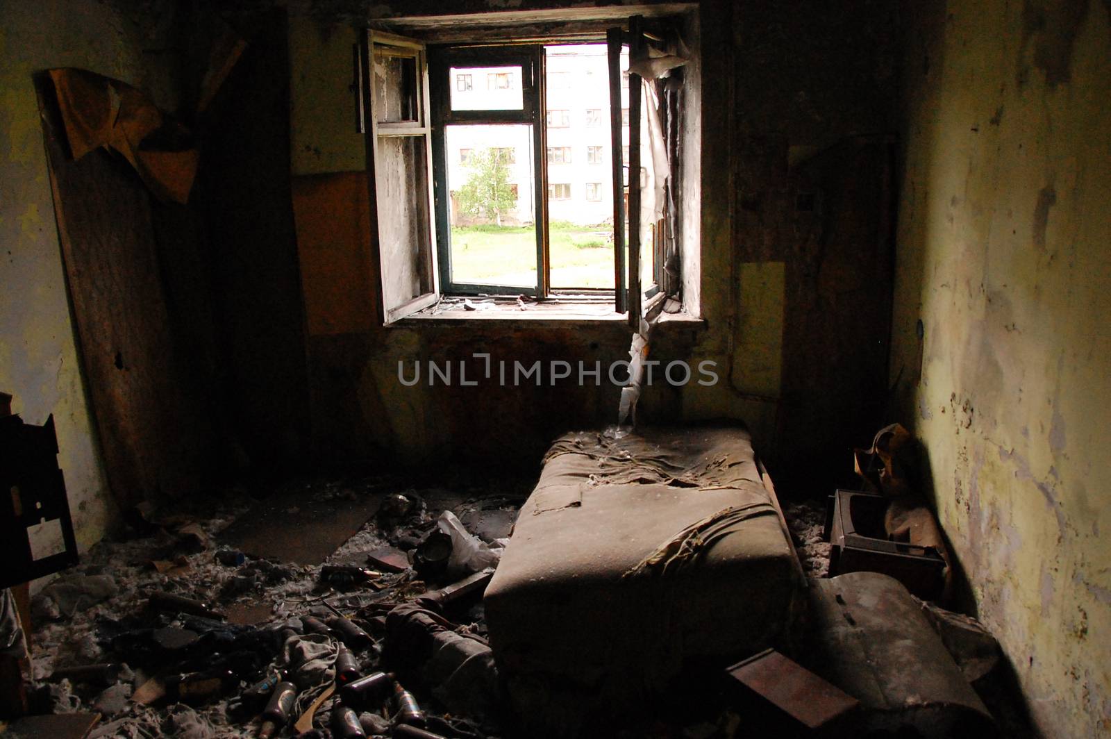 Old bed and rubish at abandoned apartment, Magadan region, Russia