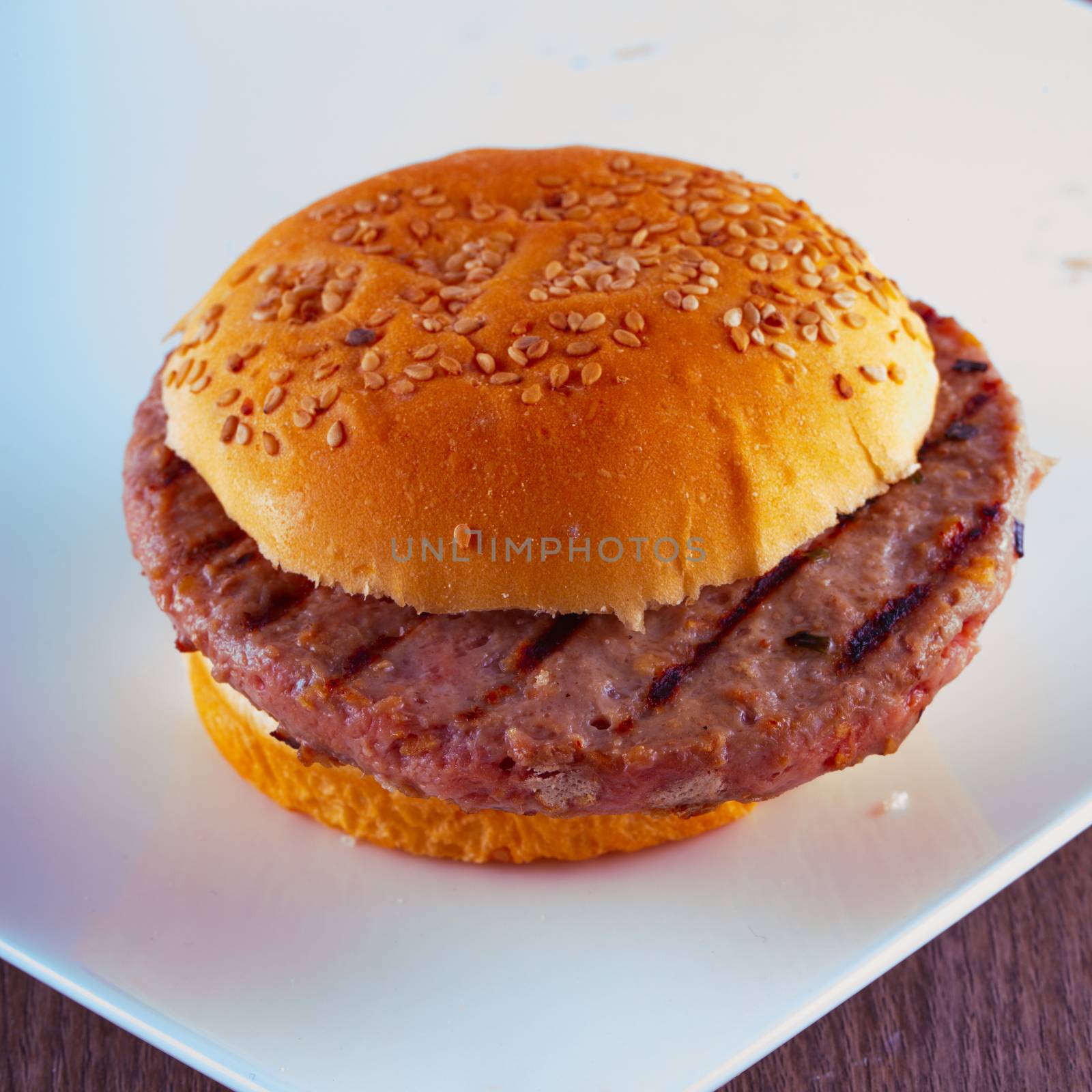 Hamburger over a white plate, square image