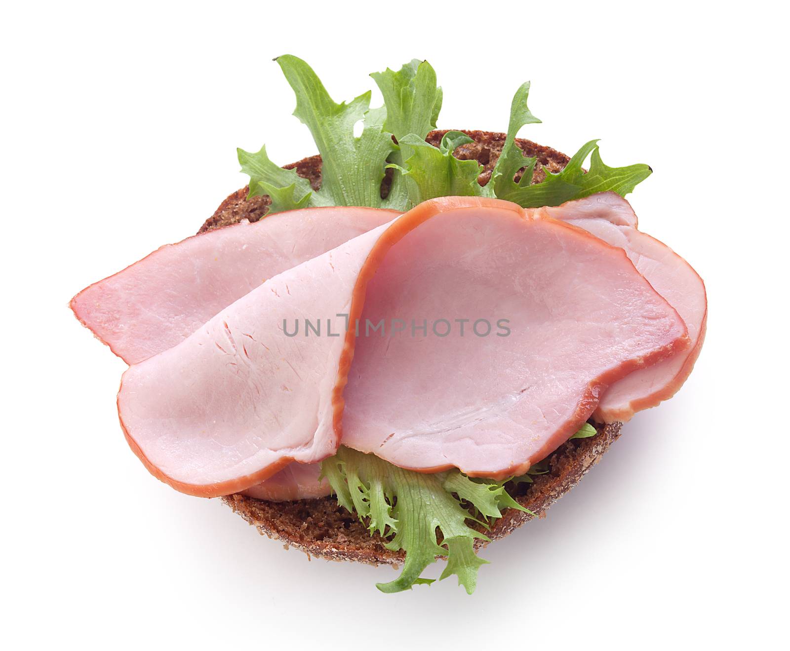 Sandwich with rye bread, pork loin and fresh green lettuce on the white plate