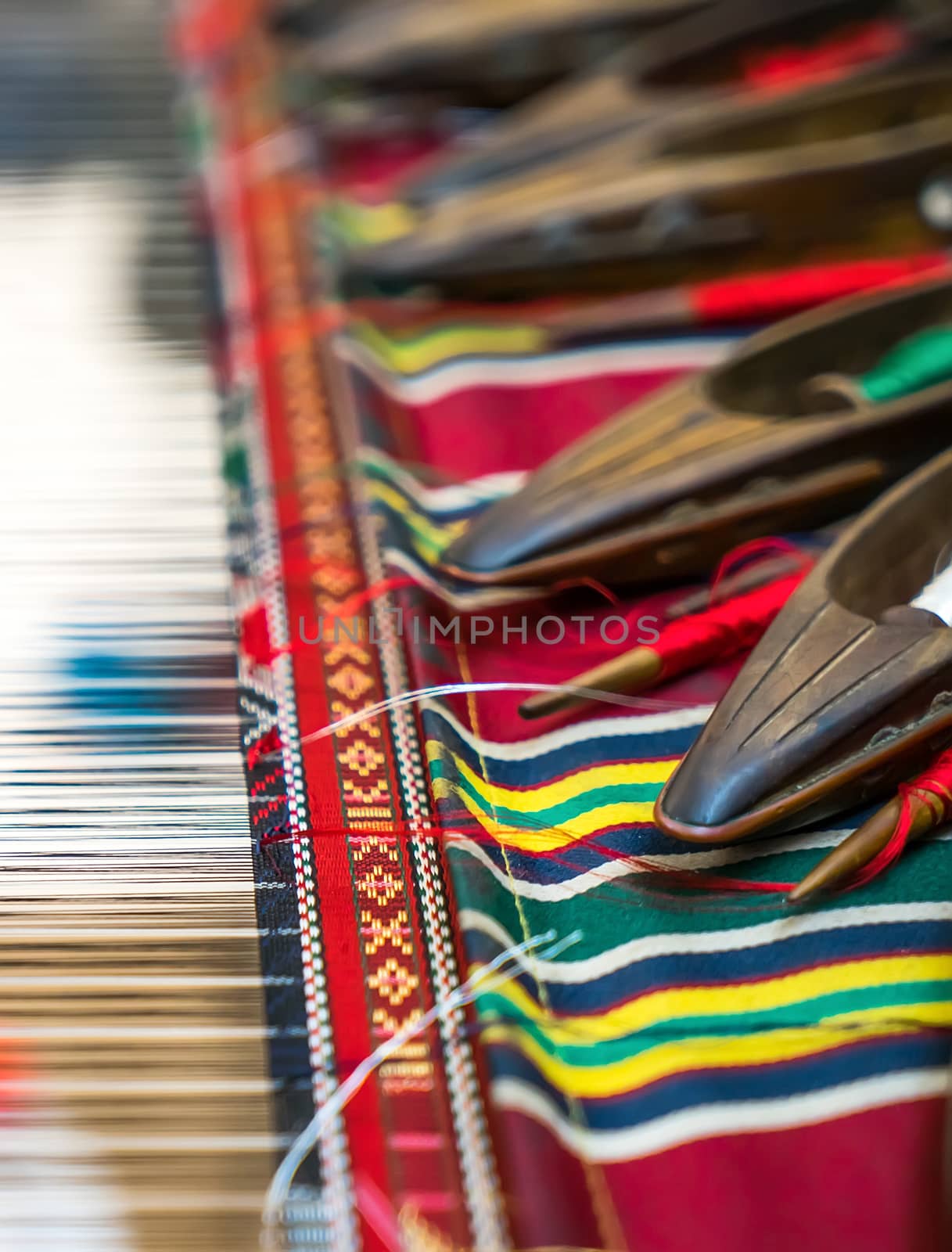 Weaving shuttles and colorful textile with pattern