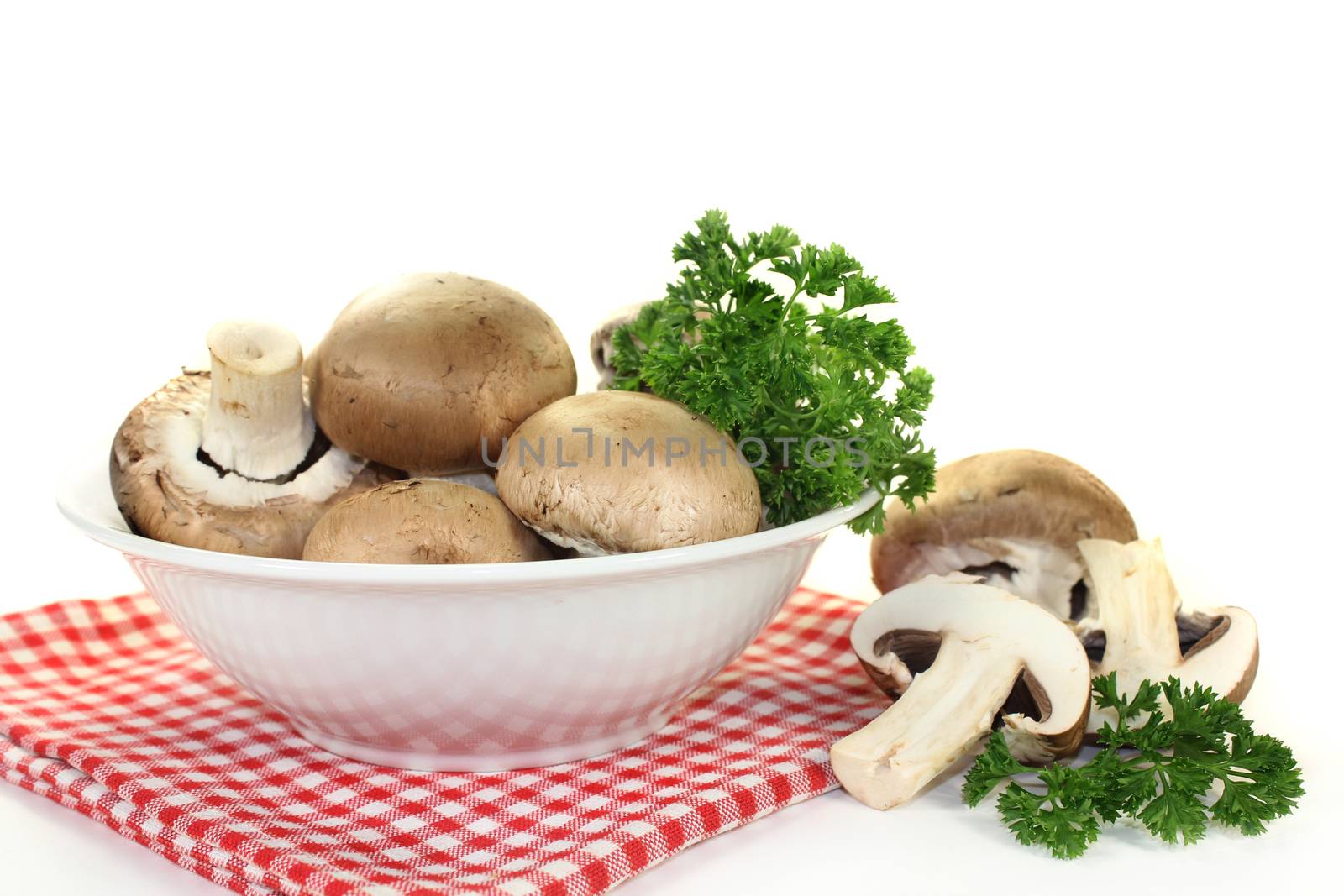 a bowl of brown mushrooms and parsley