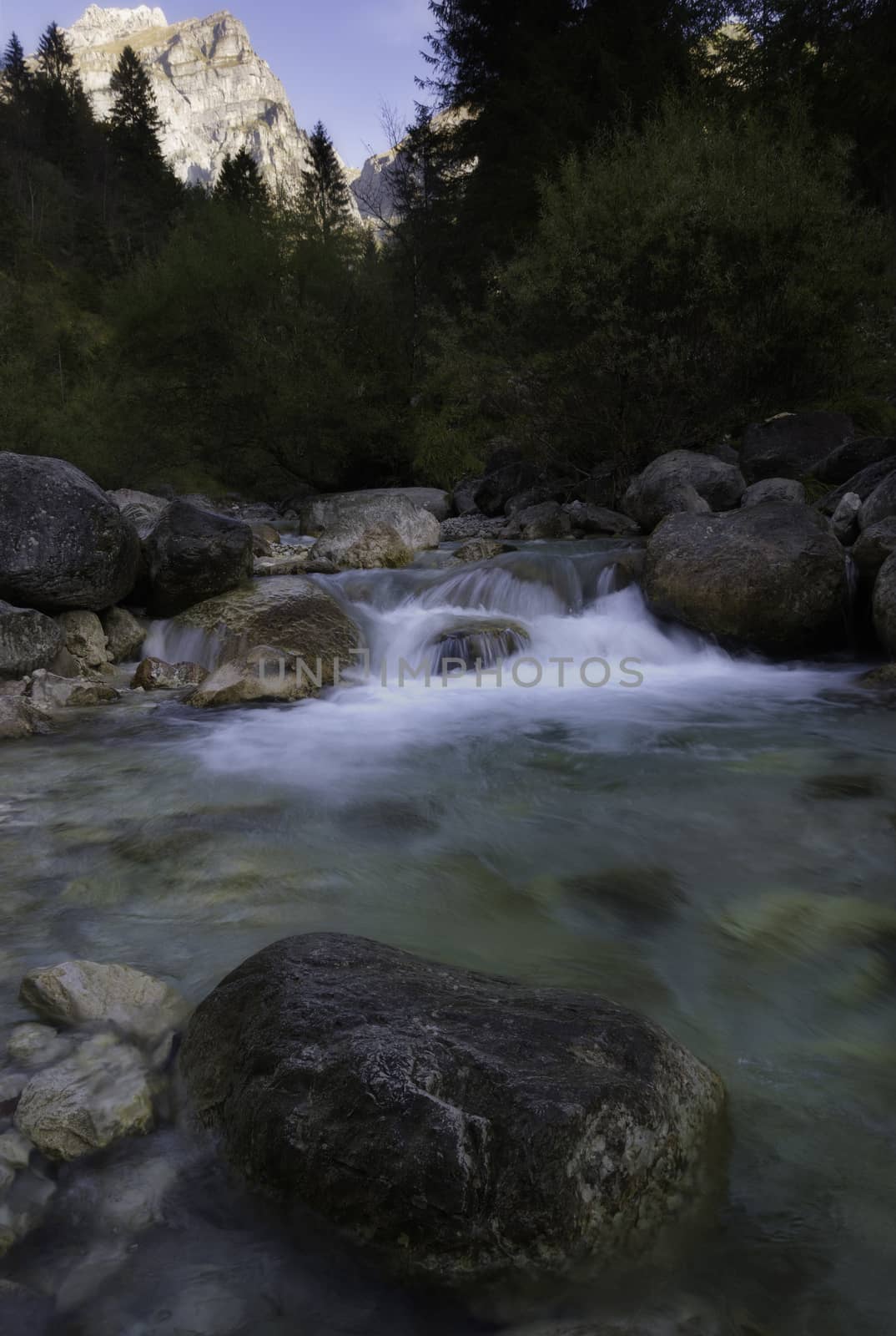 Alpine torrent with a mountain in the background by enrico.lapponi