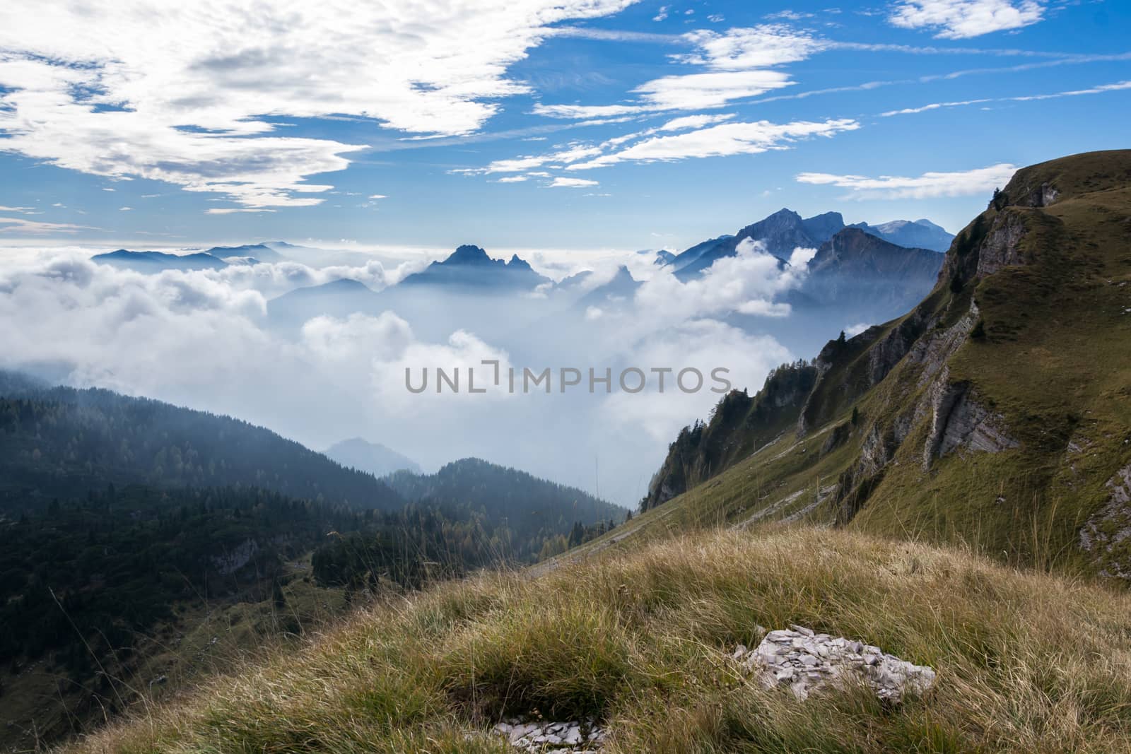 Italian dolomites during a sunny day with a sea of clouds