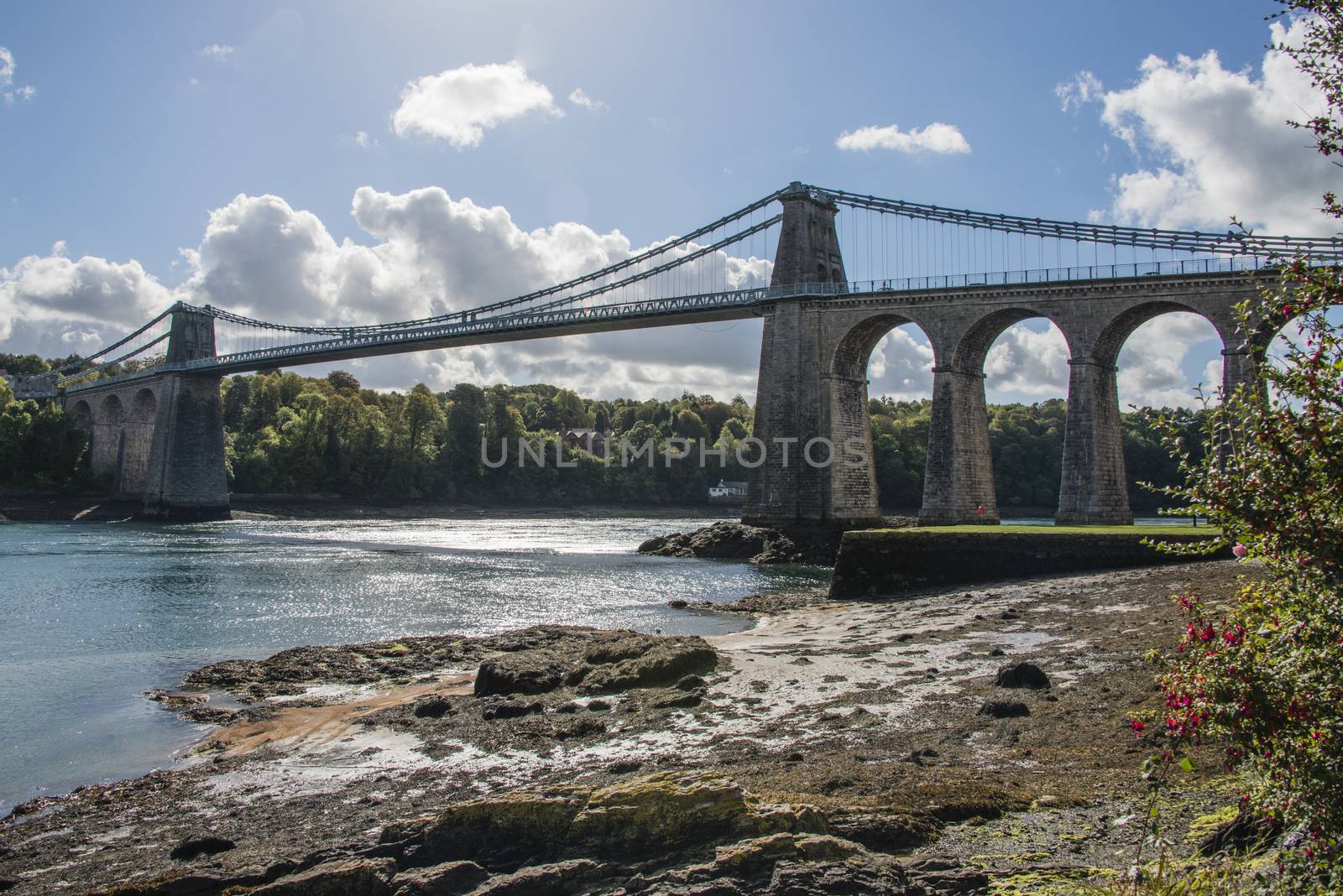 A view of the historic Menai suspension bridge spanning the Menai Straits, Gwynnedd, Wales, UK.