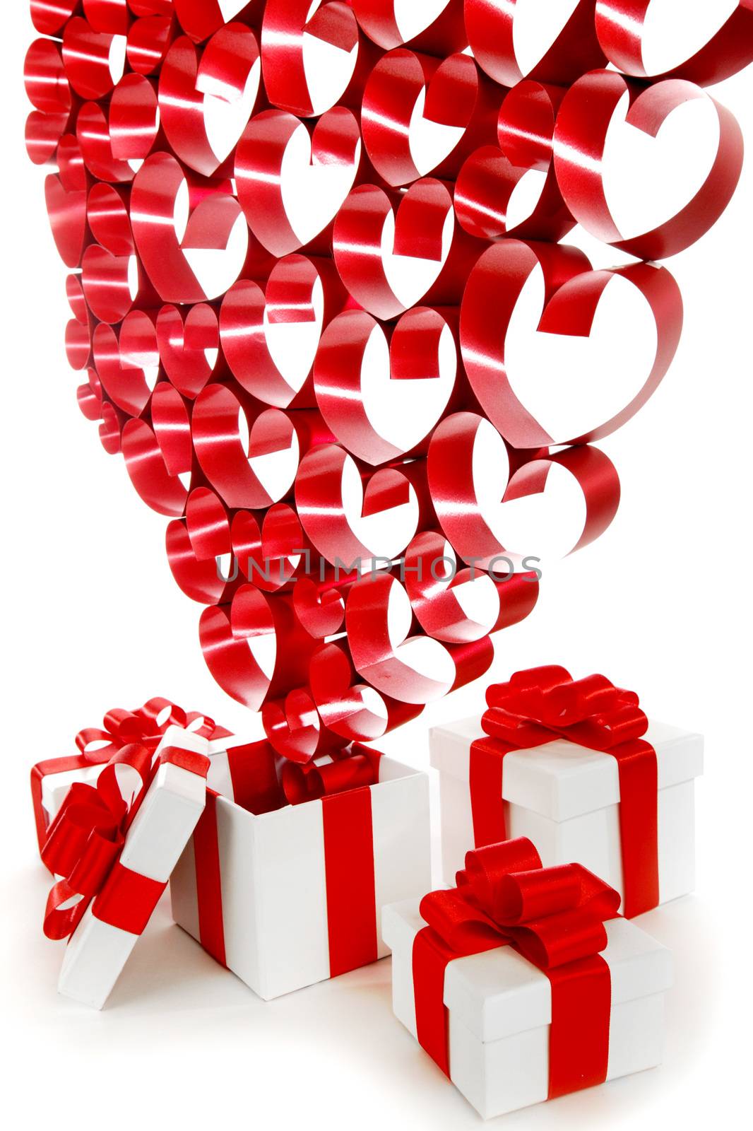 Valentines day gifts in white boxes with red ribbons and hearts isolated on white