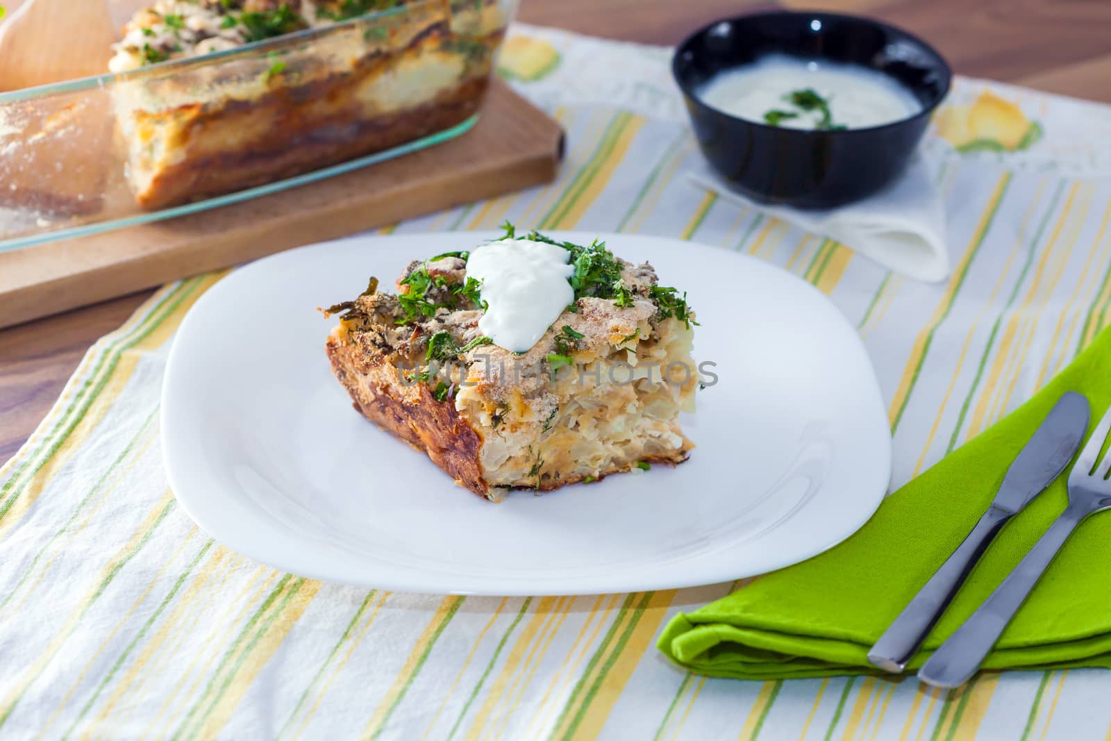 Cauliflower baked with eggs, cheese and dill on top