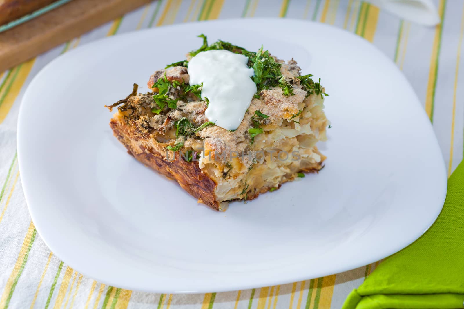 Cauliflower baked with eggs, cheese and dill on top