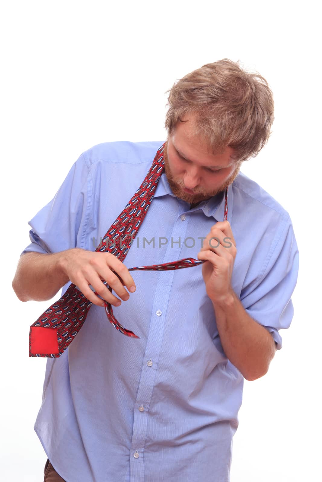 Man trying to bind a tie on his neck 