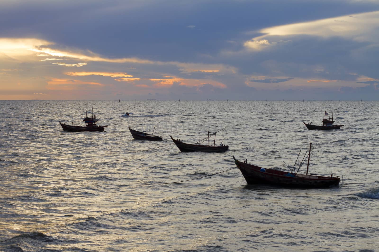 Silhouette of boats at sea during sunset