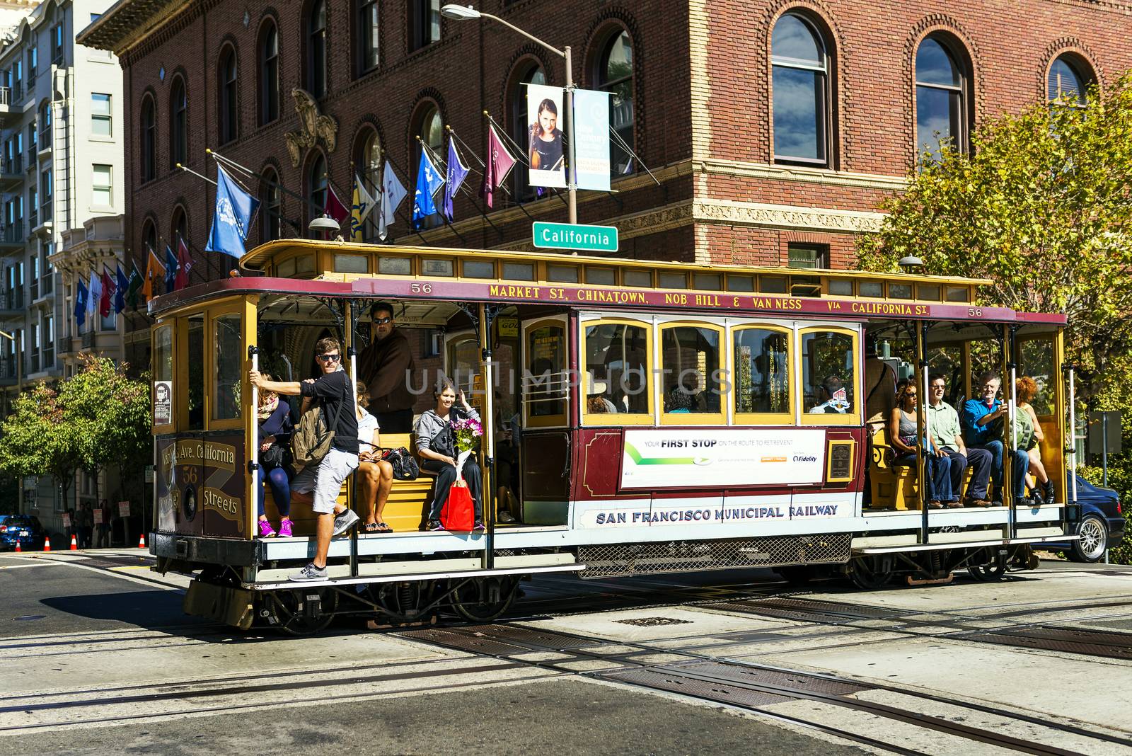 SAN FRANCISCO - OCT 06: Passengers enjoy a ride in a cable car on Oct 06, 2012 in front of famous Transamerica building in San Francisco. It is the oldest mechanical public transport in San Francisco which is in service since 1873. 